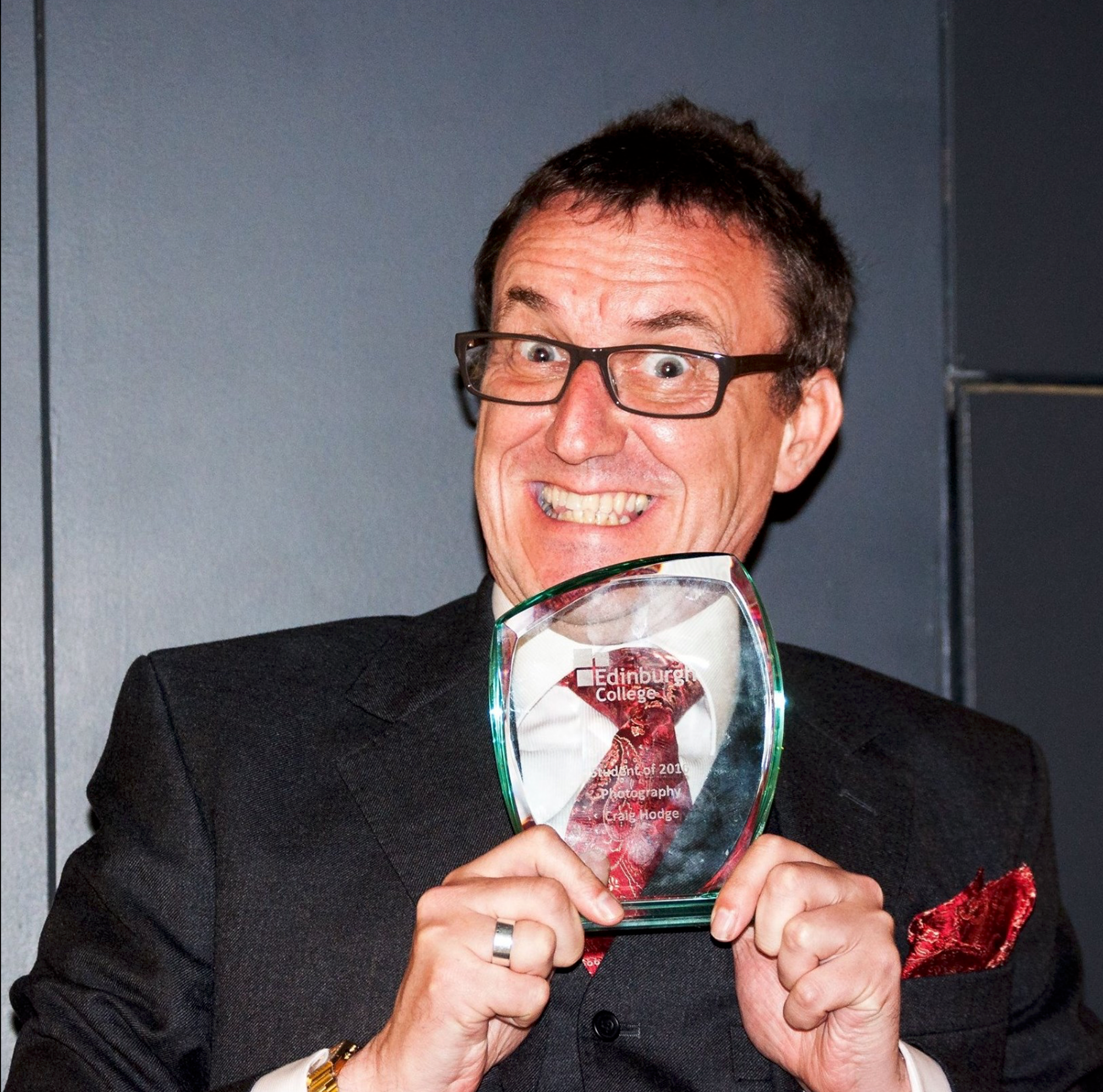 Photograph of Craig Hodge holding a glass award for receiving Edinburgh College Photography Student of the year 2016