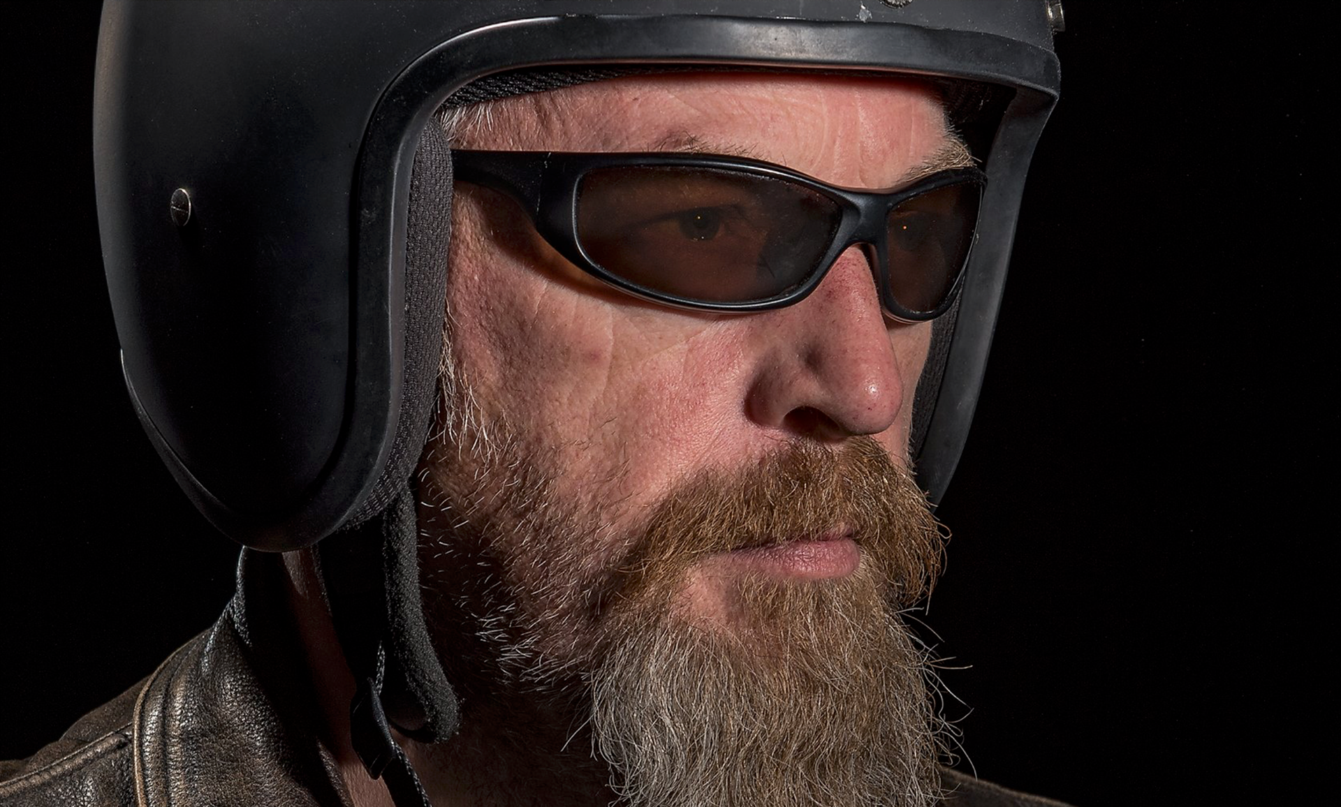 Horseshoe Inn owner Iain Dempster in his crash helmet & wearing sunglasses