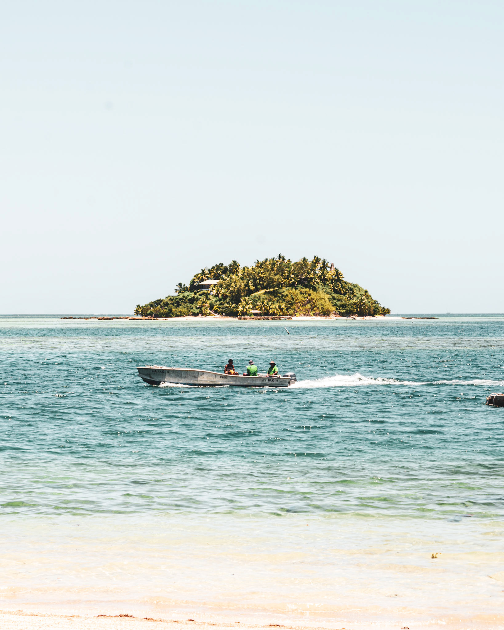 fishing boat travelling between malolo island and wadigi island fiji