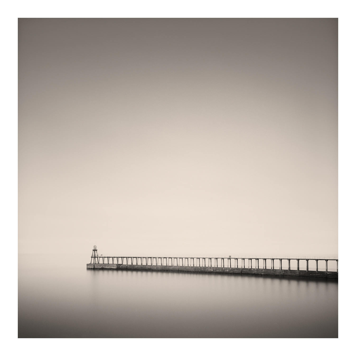 Black and white photograph of one of the harbour wall in Whitby, North Yorkshire, England