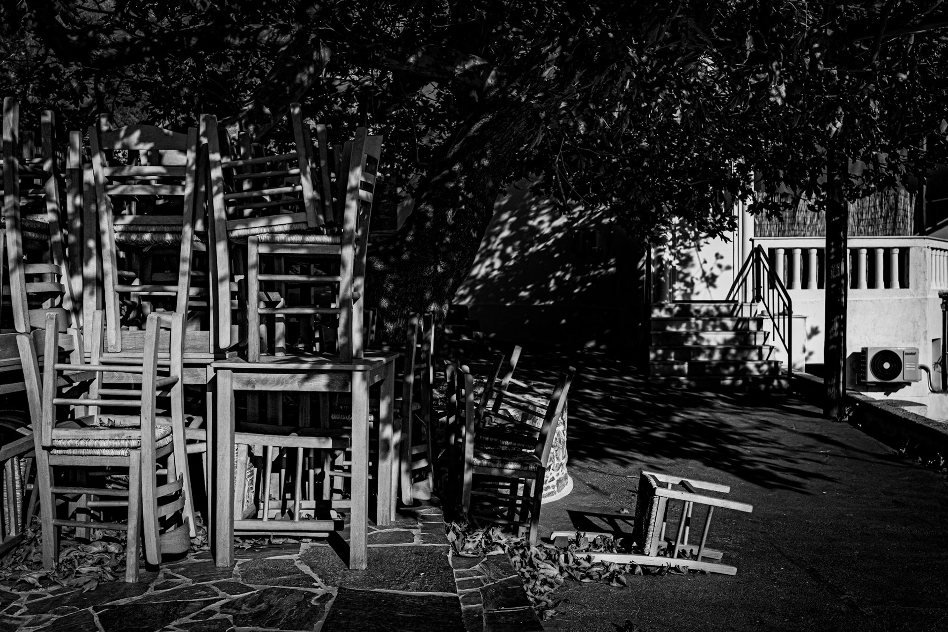 Off Season - Greek taverna chairs resting in November Sun