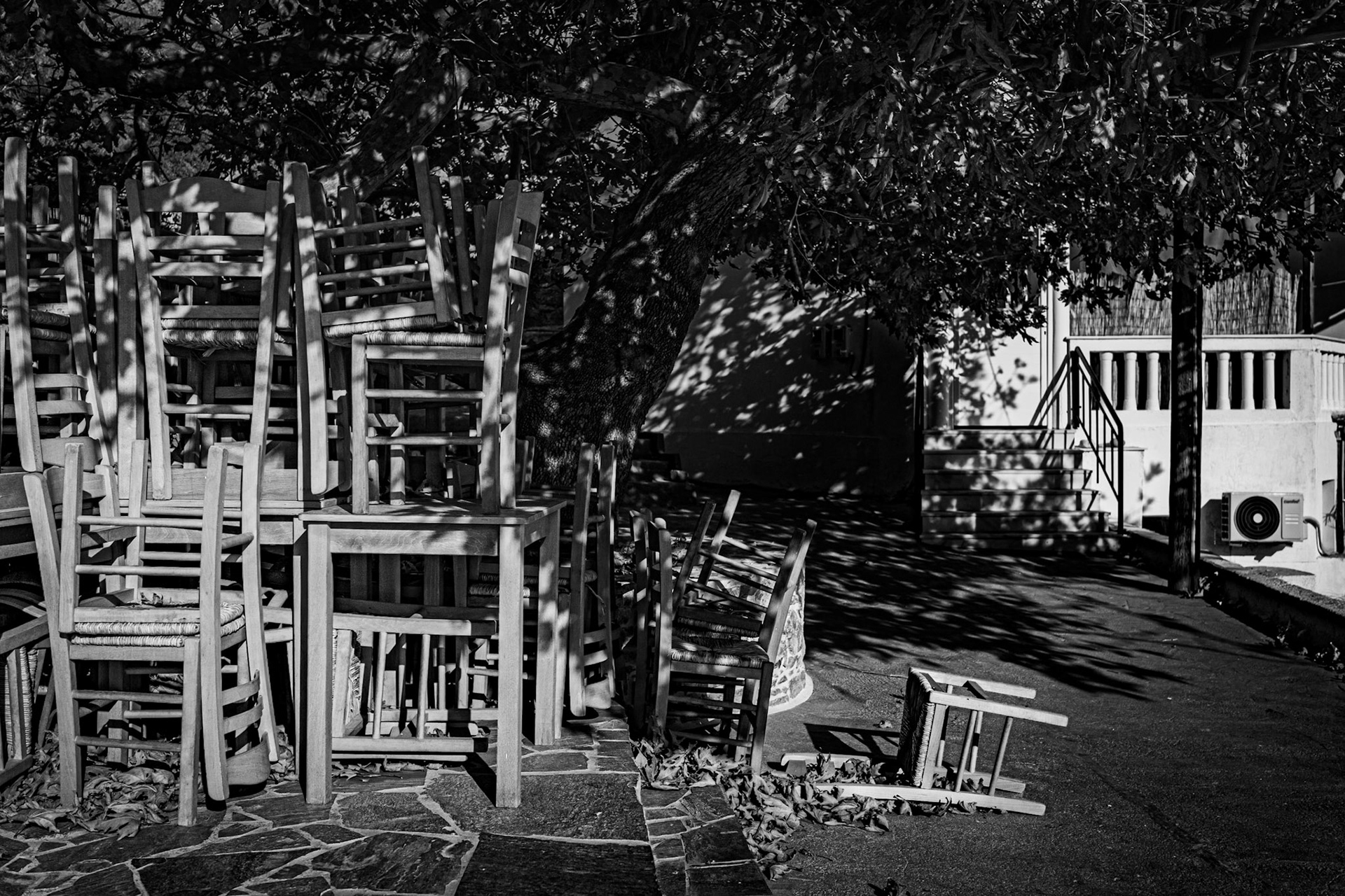 Off Season - Greek taverna chairs resting in November Sun