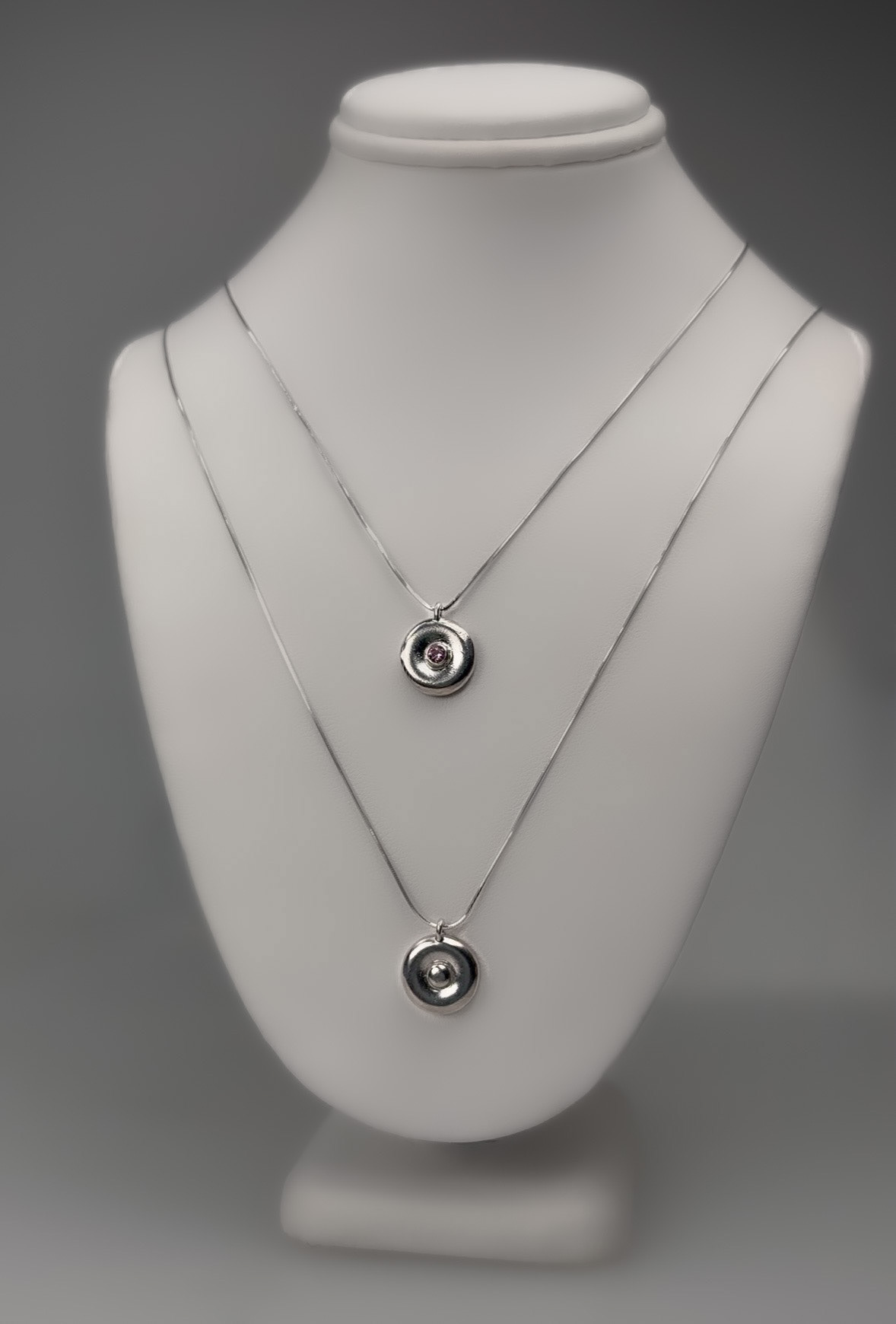 Donut necklace, 2025. Sterling silver and pink sapphire.