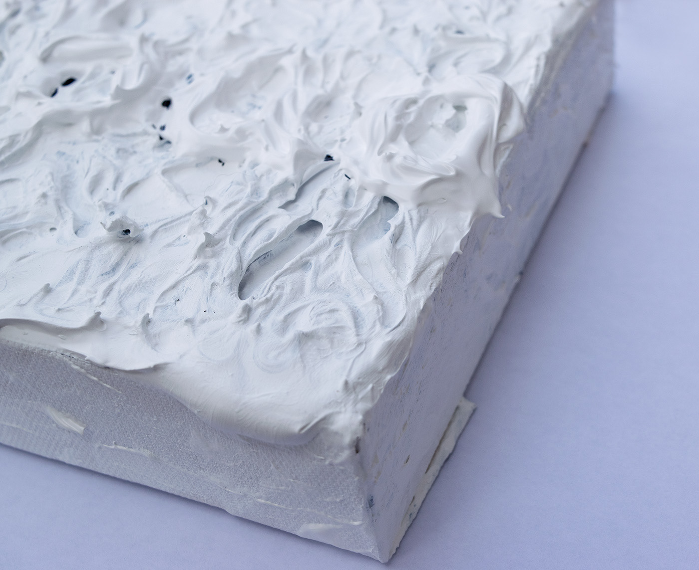 Heavily textured all white abstract painting of the word baa