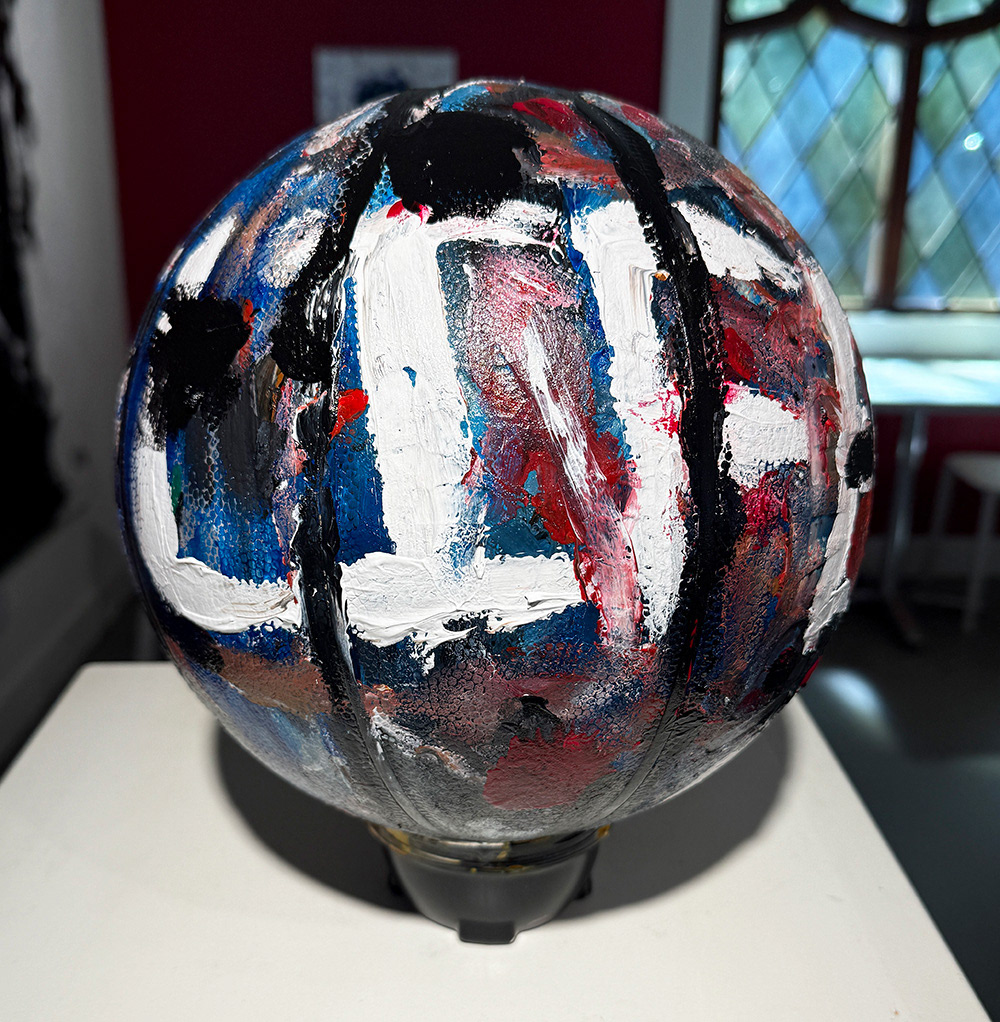 The word life and abstract textures painted on a basketball
