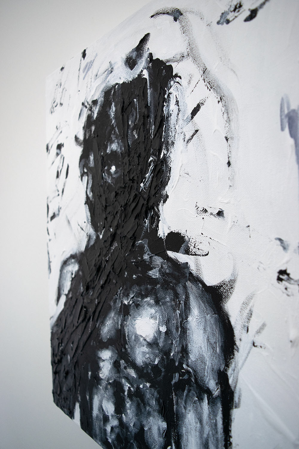 A dark hand engulfs a shirtless male figure in a black and white semi-abstract painting
