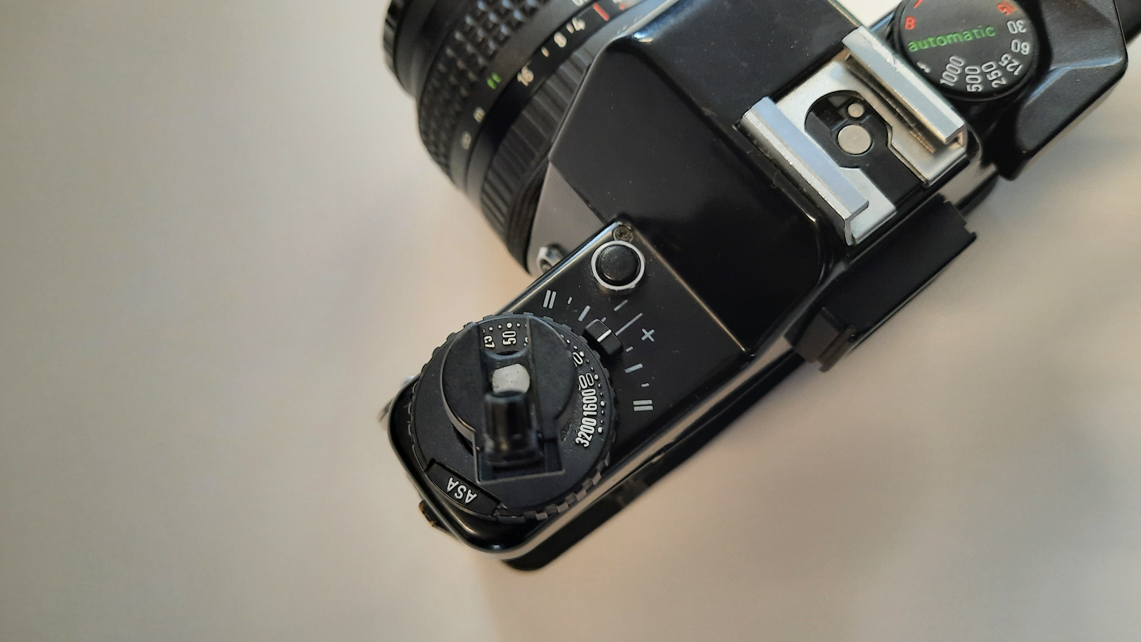 The film ISO selector and back cover release on a film camera