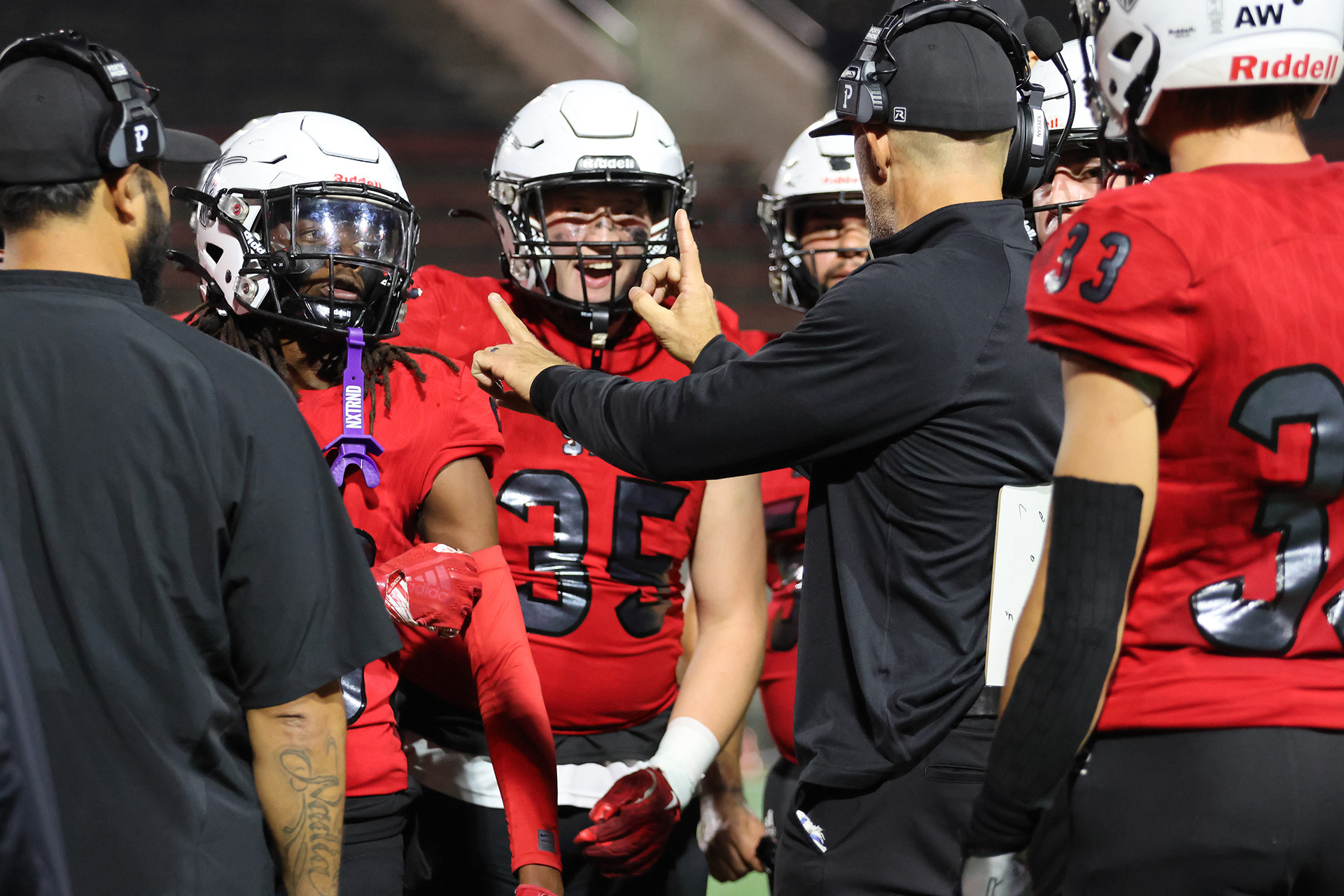 Defensive Coordinator, Adam Nyssen is reviewing a few different signals with his players, which specify what coverages to run to matchup agaisnt the offensive players.