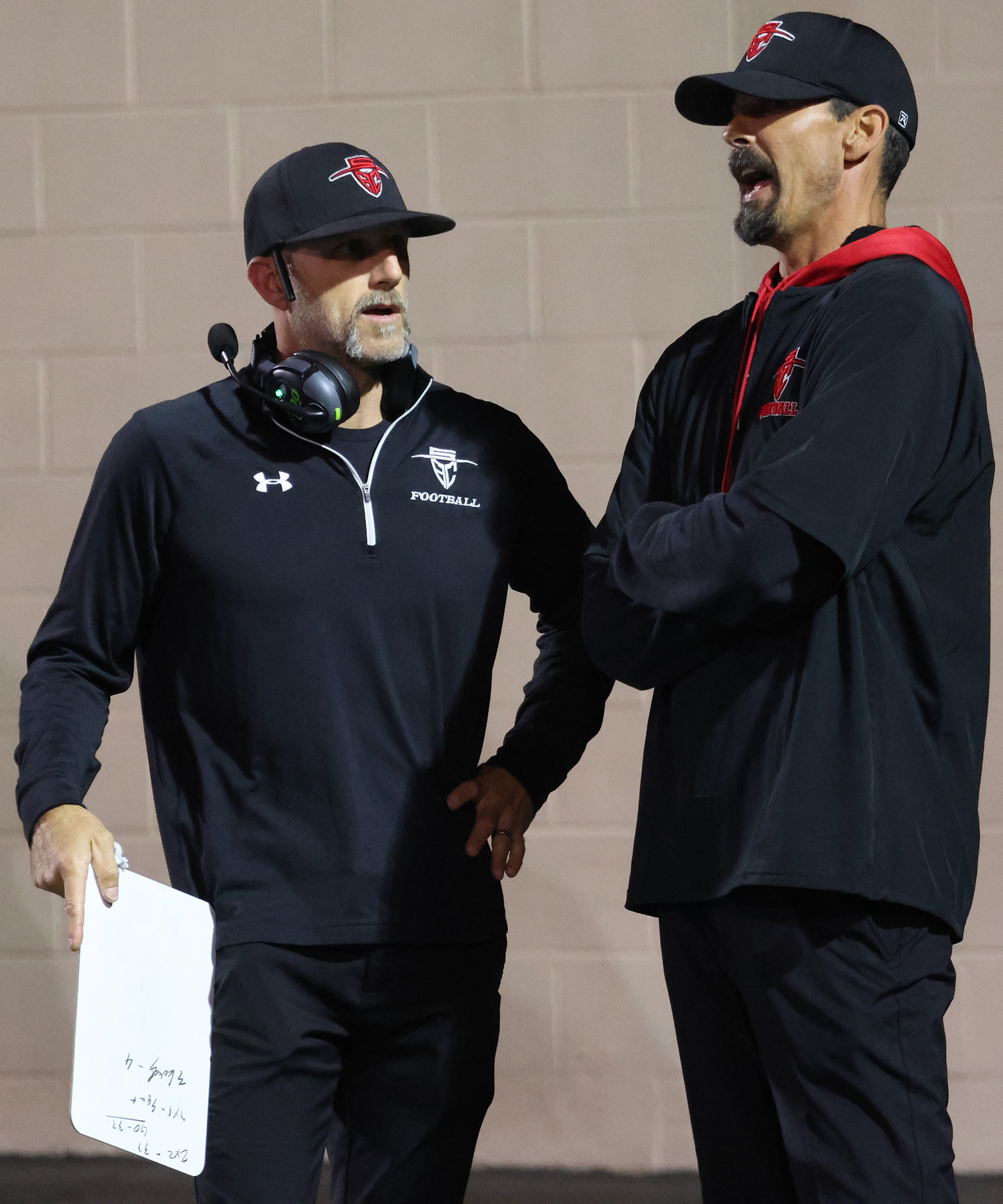 Co-head Coach Adam Nyssen and Defensive Line Coach James Guglielmana are discussing both offensive and defensive strategy. They were also seen talking back with Famers dad with little back and forth banter. (could not get a shot of that all together though sadly.)