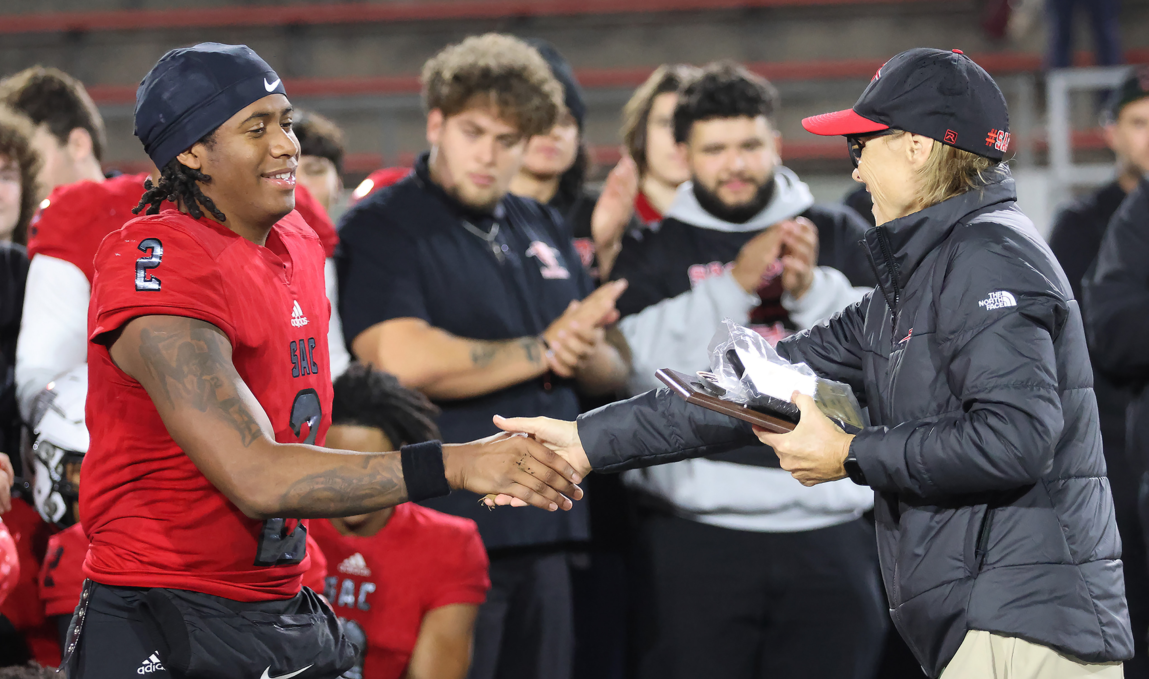 Athletic Director Mary Hegarty hands a award to James Farmer for Santa Ana's College Player of the Game for his four catches 44 yards and two touchdowns. In what was his last game at Santa Ana(since he is a sophomore at a 2 year) he will be looking to transfer his talents to any 4 year college that has been scouting him to this point.