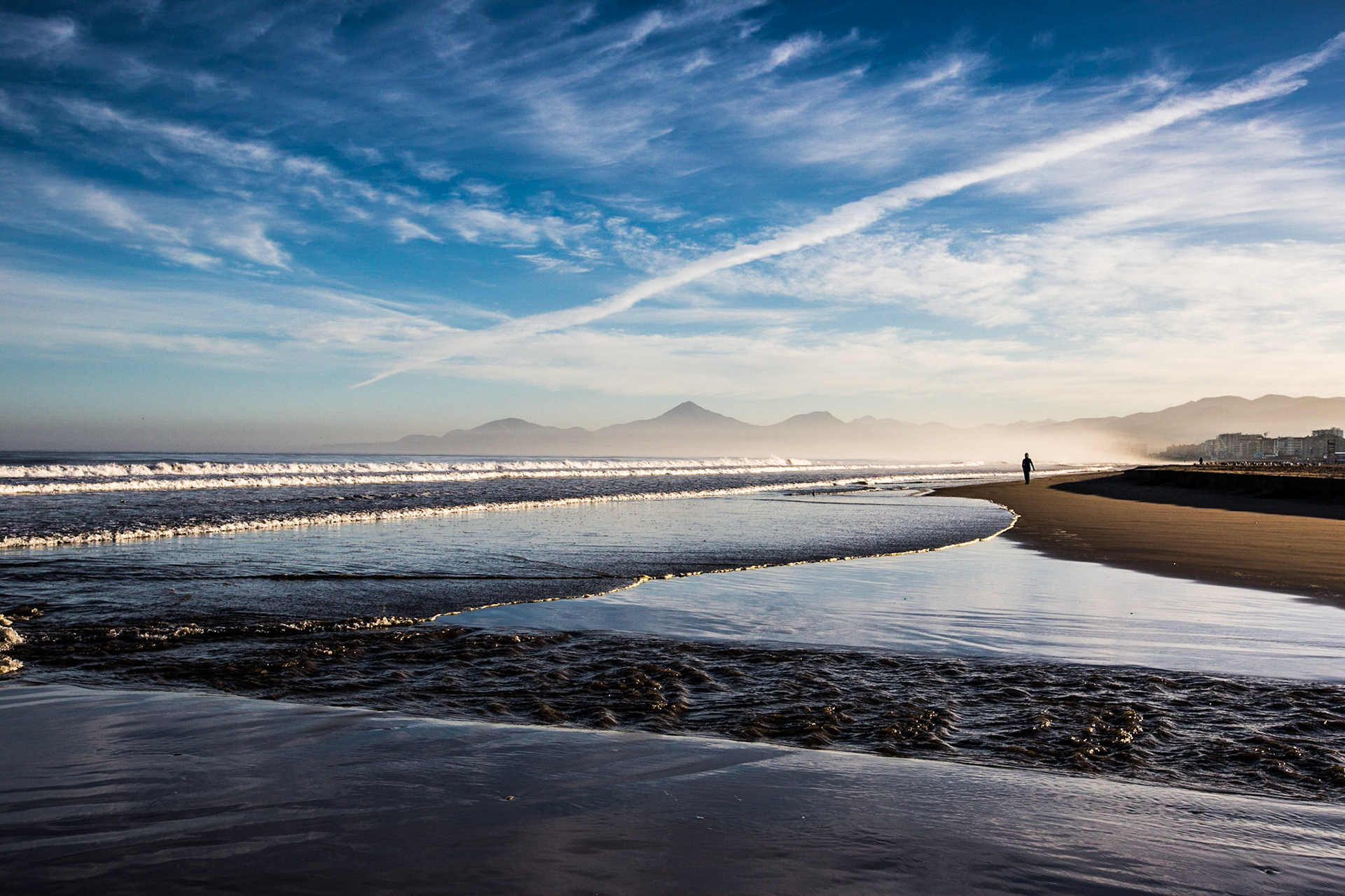 La Serena, Chile. The rising sunlight shines on a calm Pacific beach. Taken April 29, 2013.