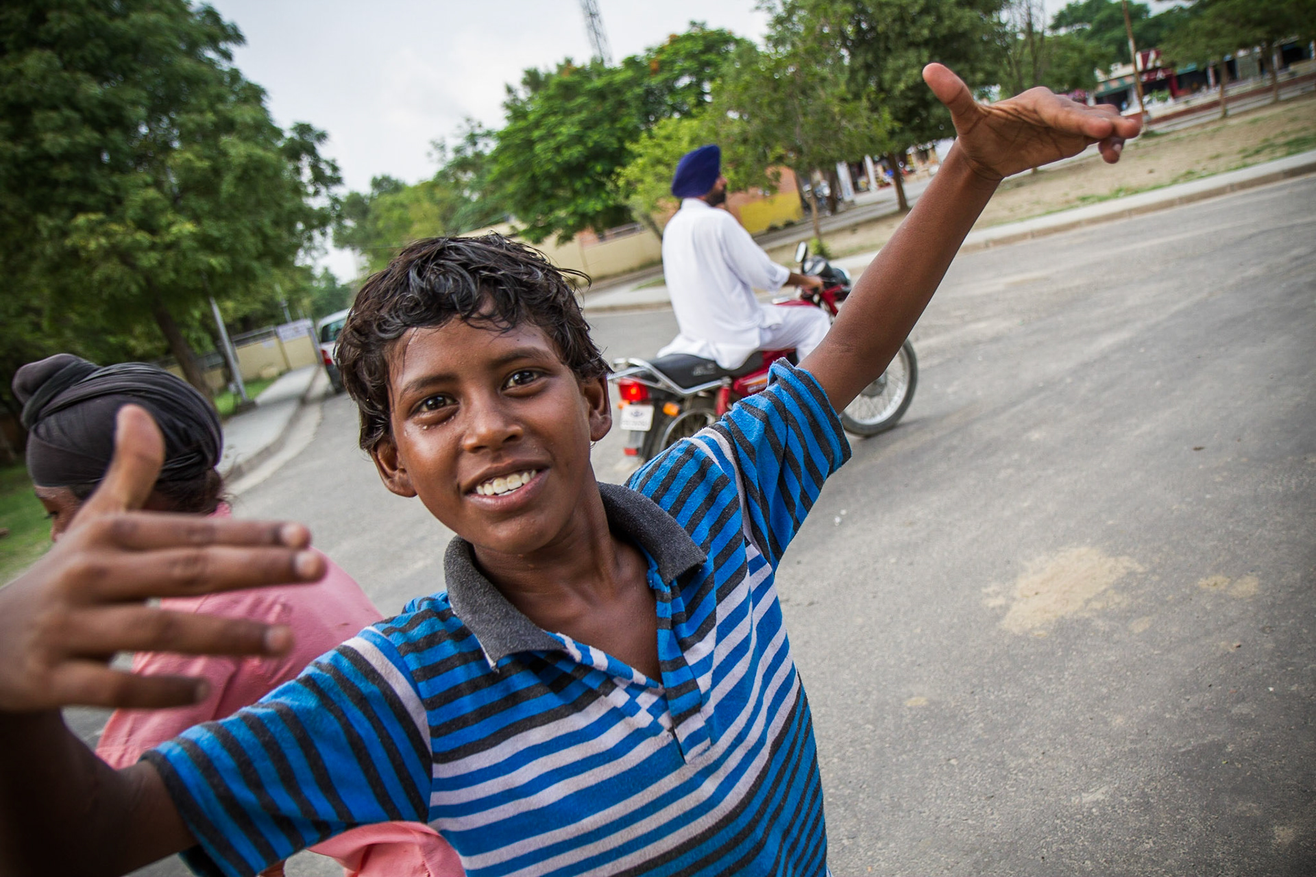 Near Ludhiana, Punjab, India. A boy from a market stall poses for a photo. Taken September 1, 2012.