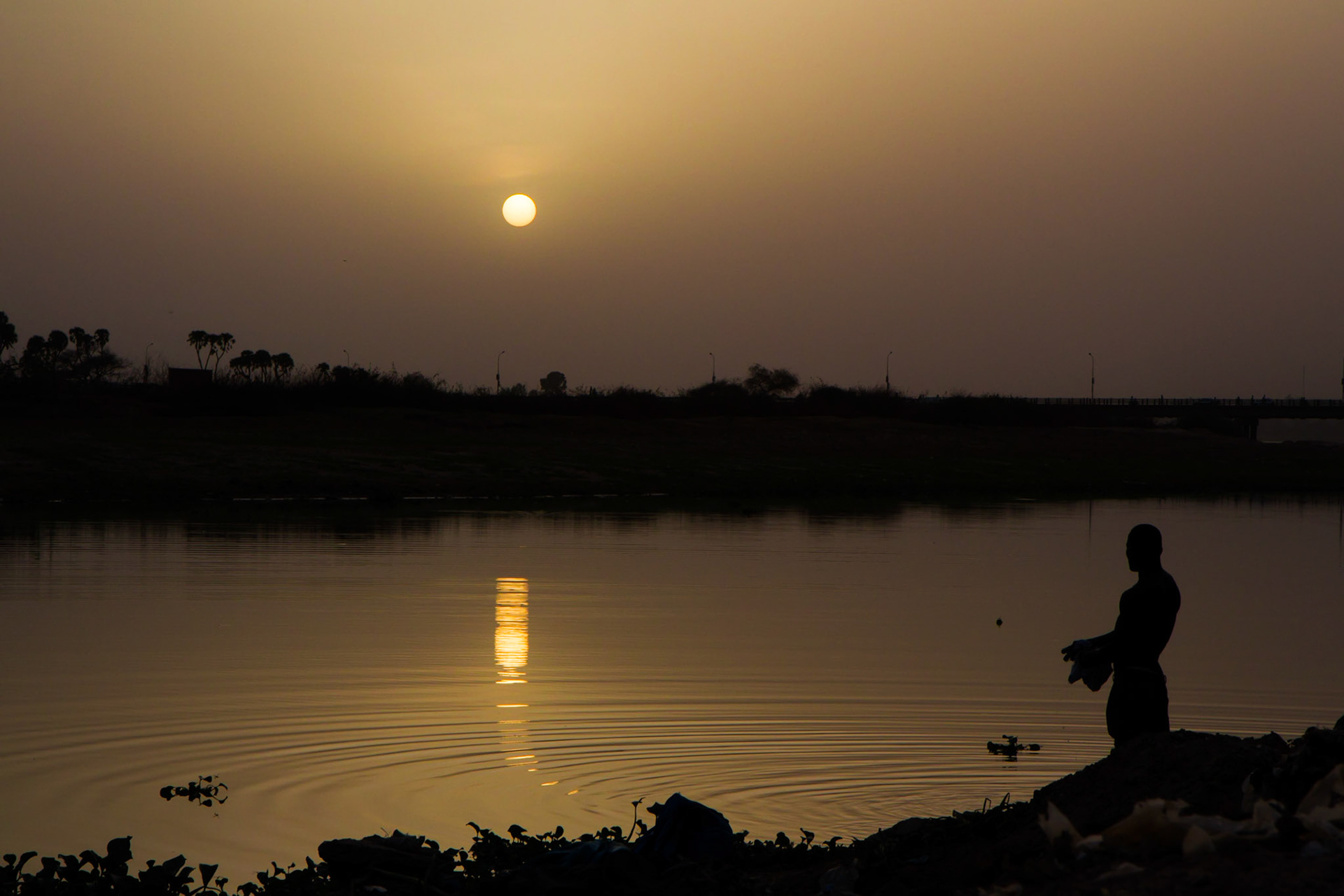 Niamey, Niger. A man washes clothes on the Niger River. Taken on May 11, 2012.