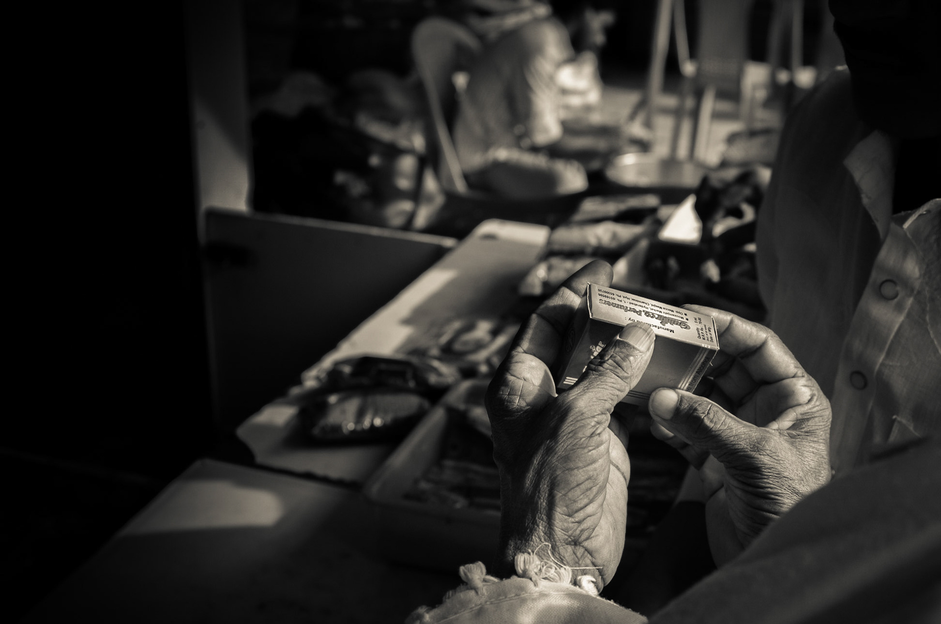 Hyderabad, India. A man inspects the label of a perfume box. Hyderabad is known for its local perfume industry. Taken September 4, 2012.