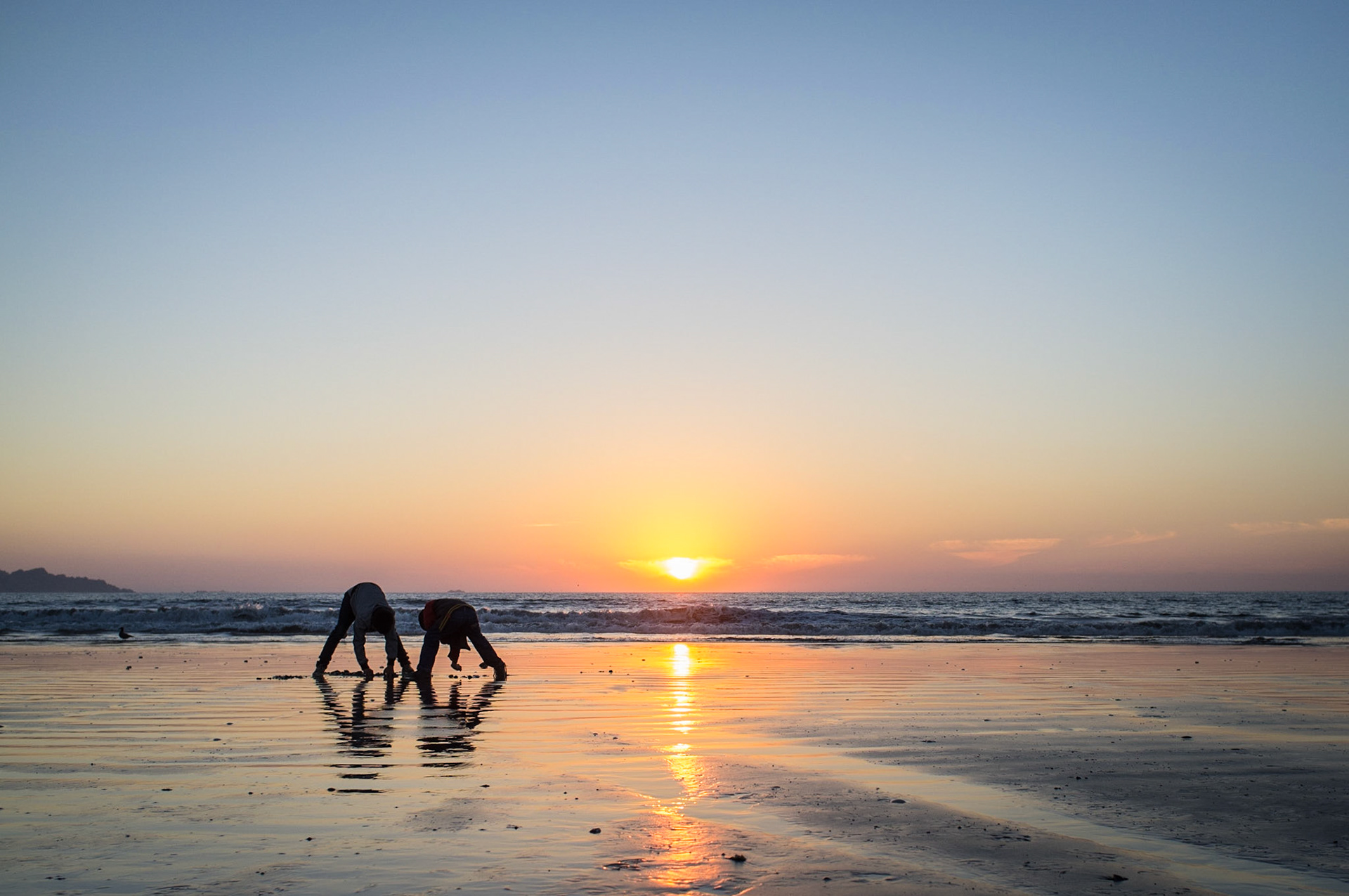 La Serena, Chile. Two boys dig for clams and other intertidal critters on the beach. Taken April 28, 2013.