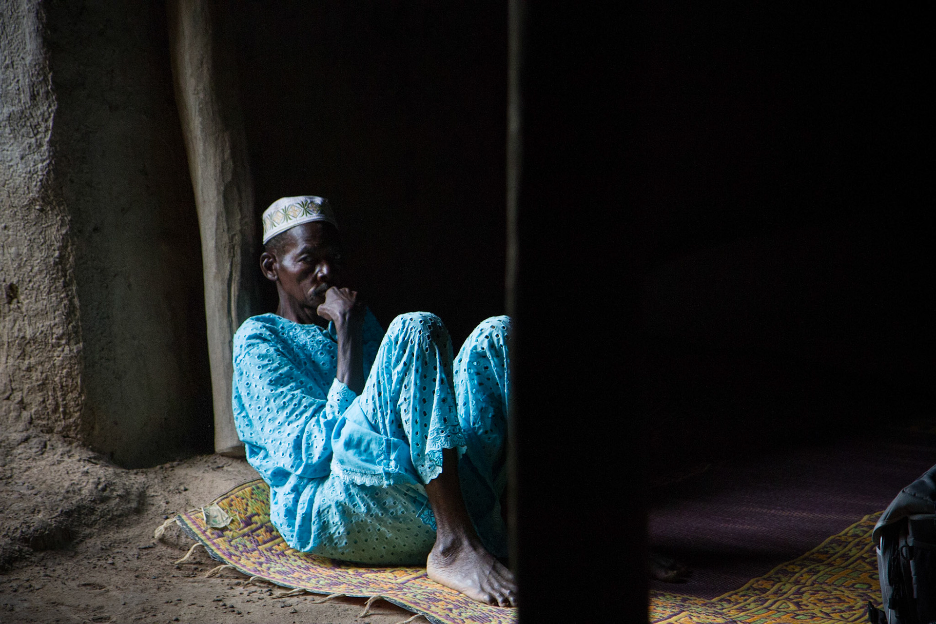 Molobola, Mali. A man rests near a door of his home. Taken July 2, 2012.