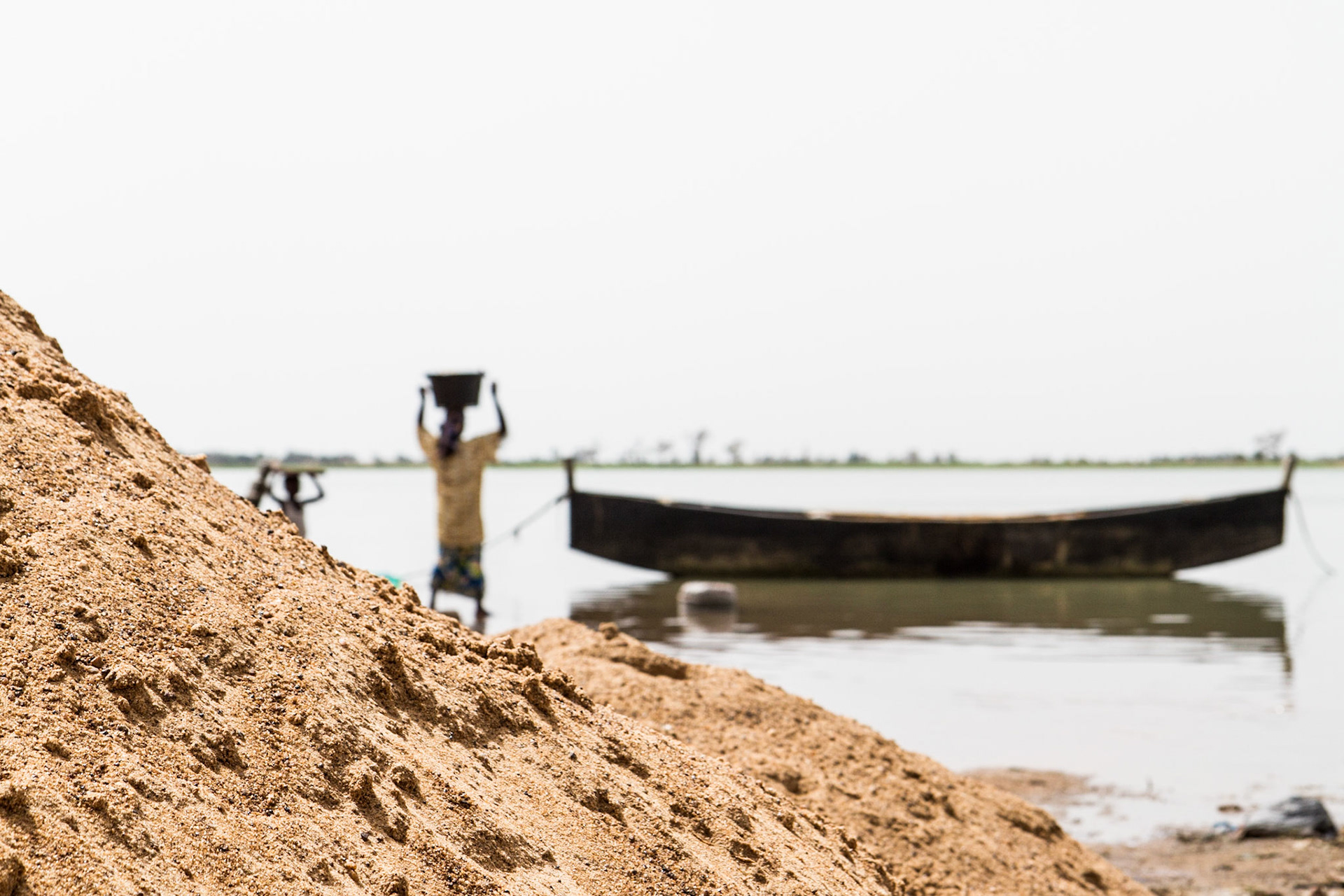 Segou, Mali. A woman carries her clothes to wash on the banks of the Niger River. Taken June 30,2012.