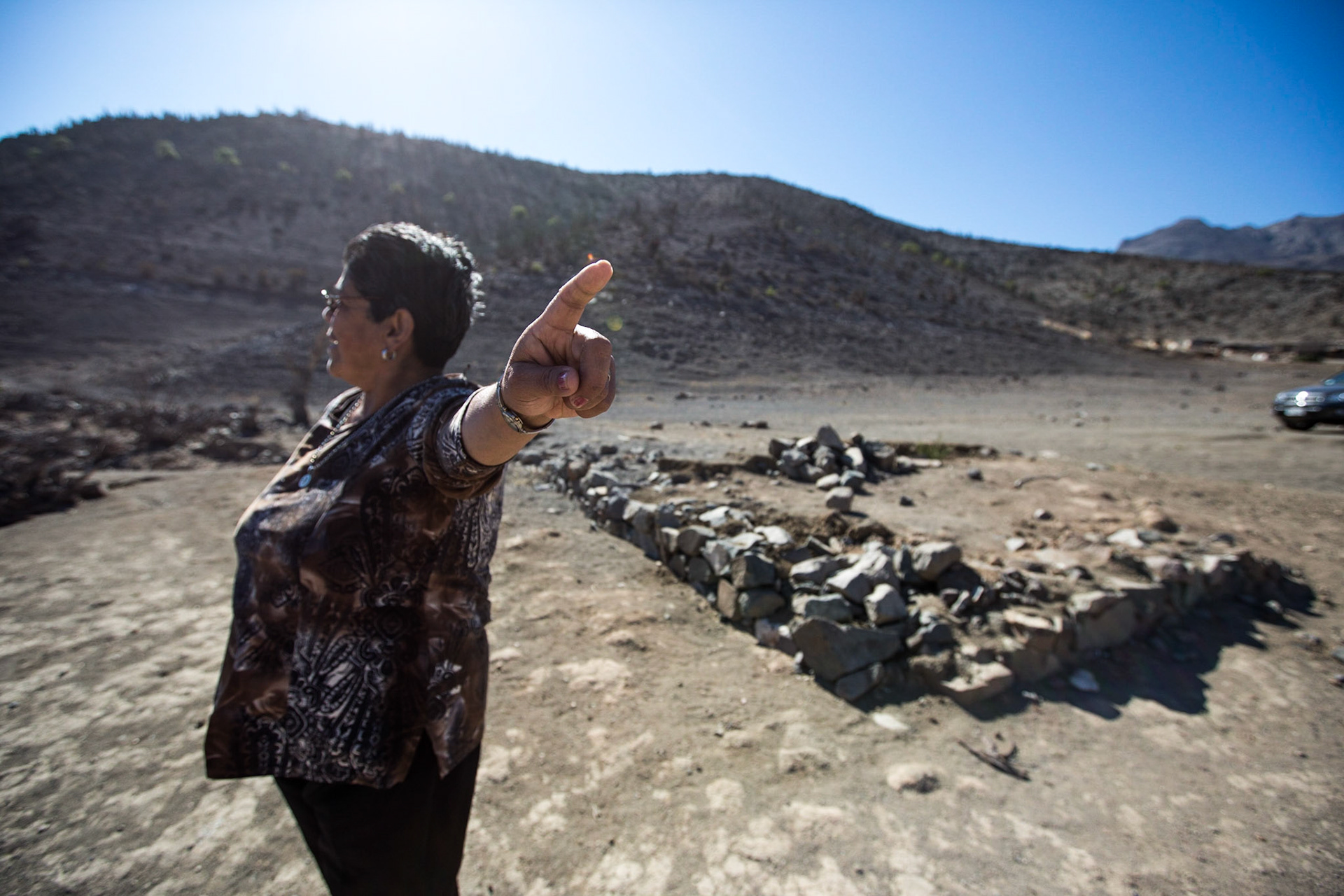 Gualliguaica, Chile. Natalia Edith Codoceo Flores points to the  original village of Gualliguaica, where she lived until the 1990s before it was flooded by the Puclaro Dam. A long lasting drought has diminished the reservoir to 10% (or less) of it's capacity. The entire old village is now exposed, as the "reservoir" essentially receded back to the original bed of the Elqui. Taken April 29, 2013.