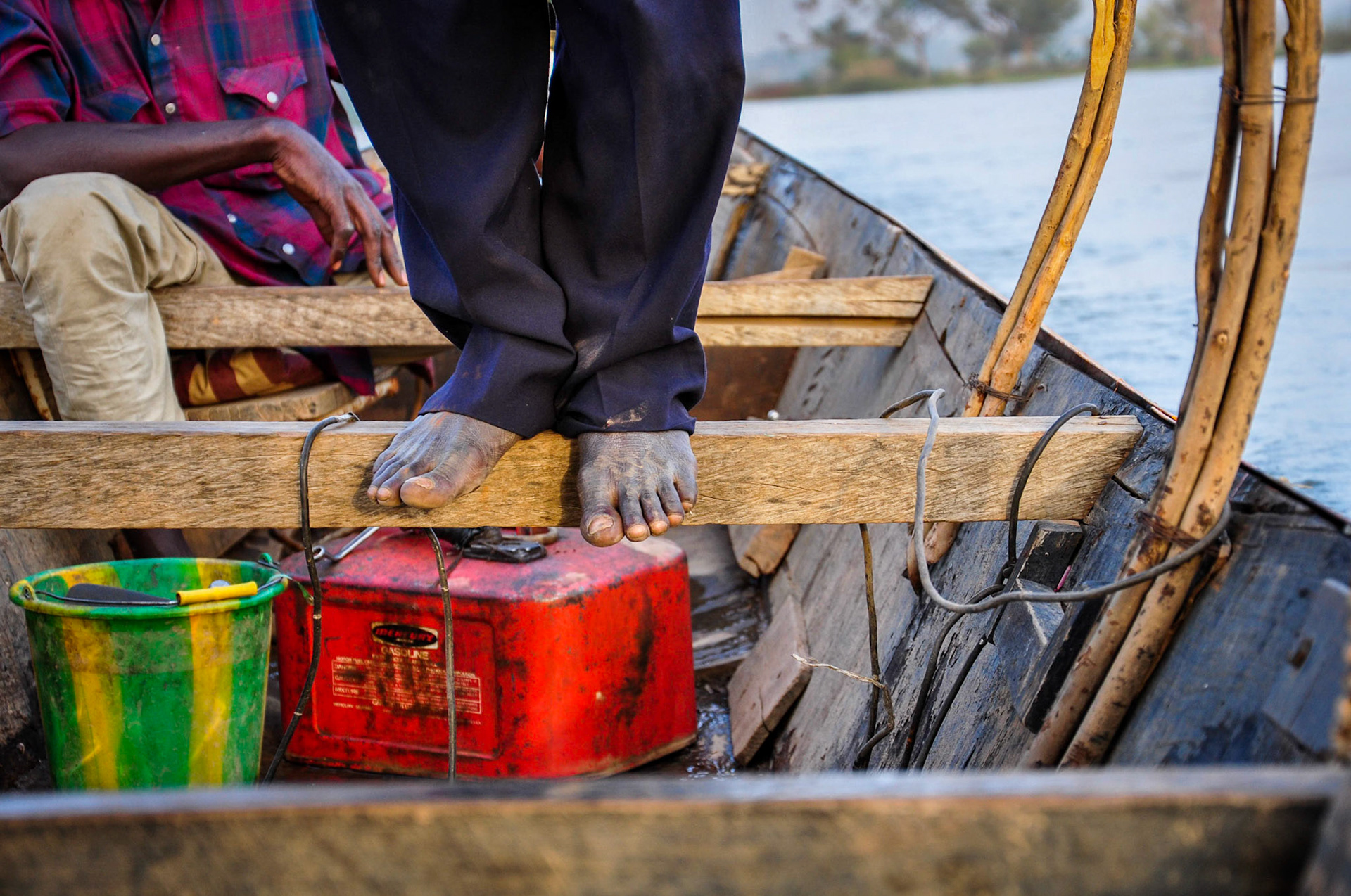Niamey, Niger.Boat captain stands to navigate teh Niger, while his mate controls the engine. Taken February 16, 2011.