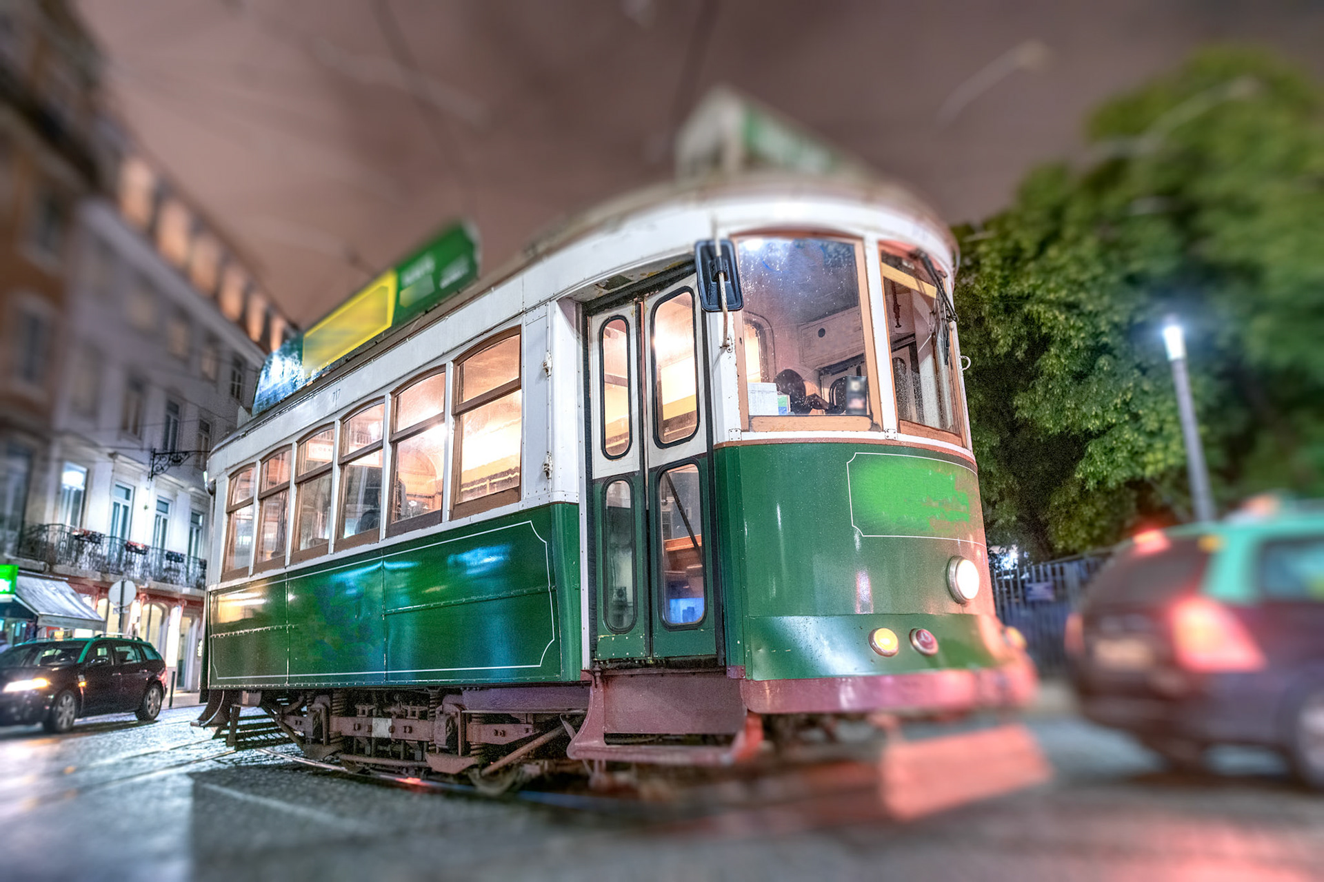 Green tram in Lisbon at night.