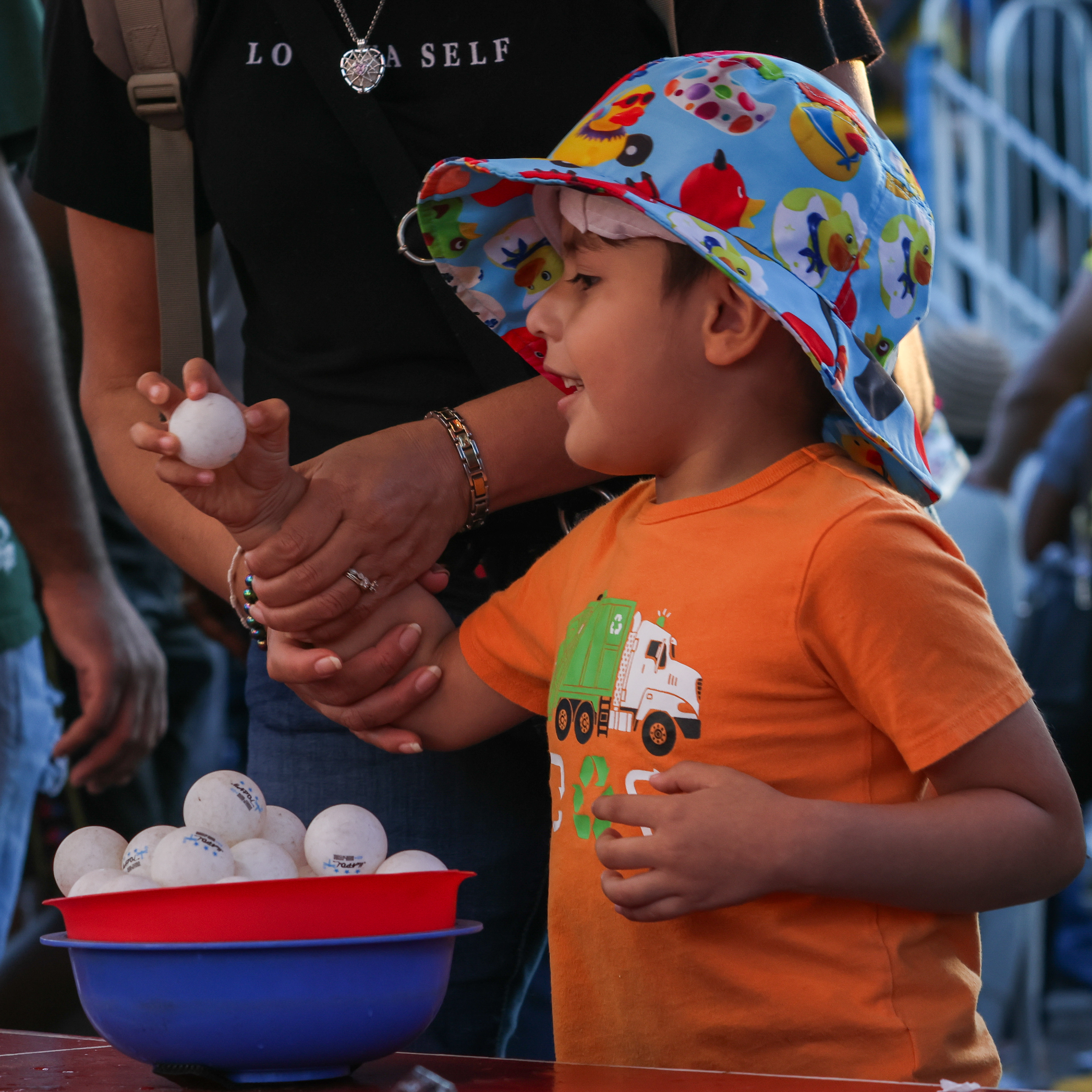 Angel Romero, 6, from Georgia competes in a throwing game to win a goldfish with his mom at the Georgia National Fair in Perry, Georgia on Saturday, Oct. 14, 2023. (Photo/ Samantha Hurley) 404 432 5747 