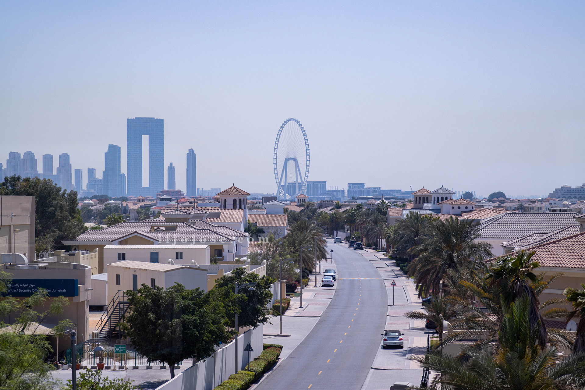 A scenic view of Dubai’s skyline from the Atlantis Monorail, featuring Ain Dubai and the city’s modern architecture.