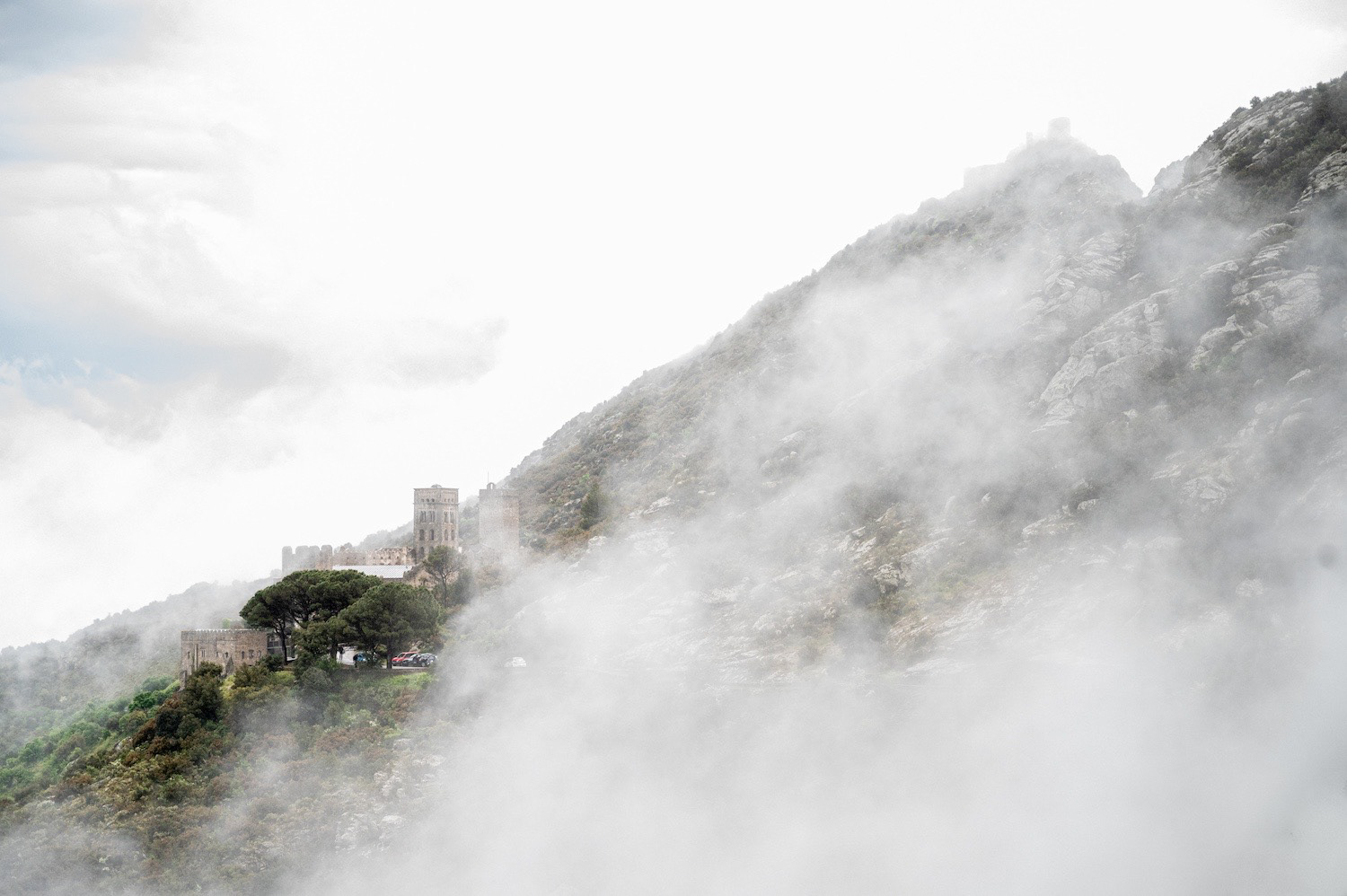 A misty day with Sant Pere de Roda (Catalonia) monastery viewd through of all kind  of  clouds