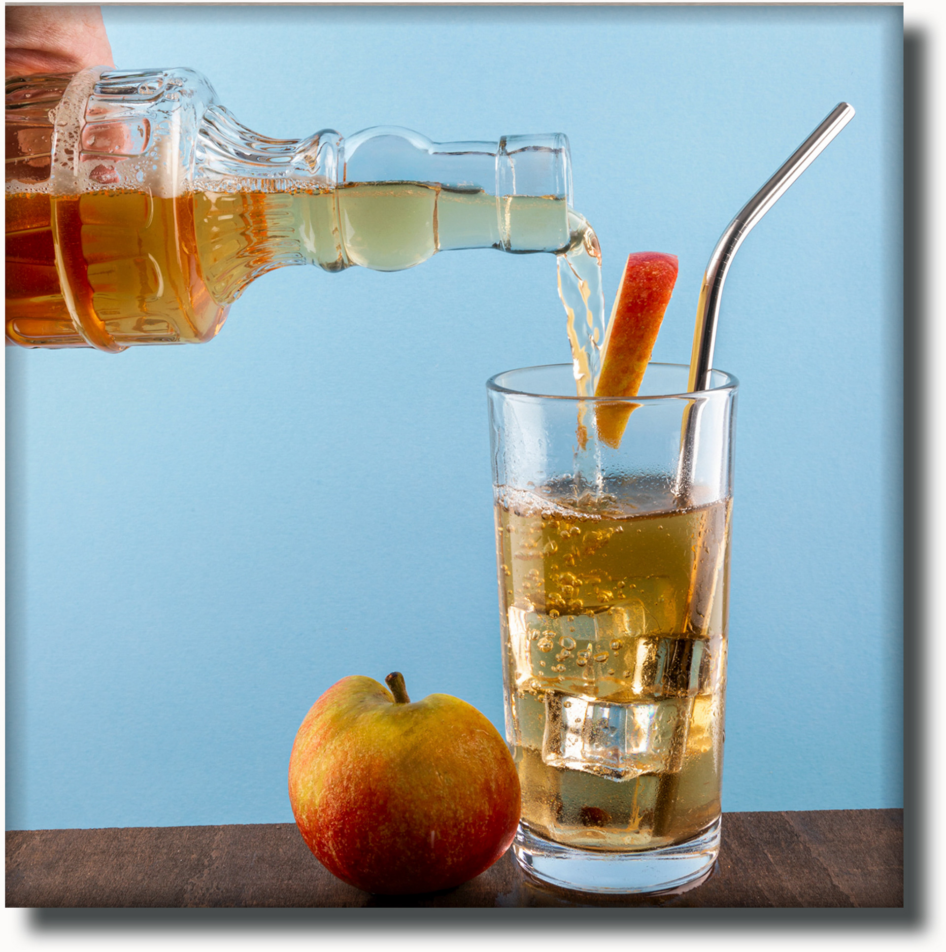 pouring apple juic into a glass