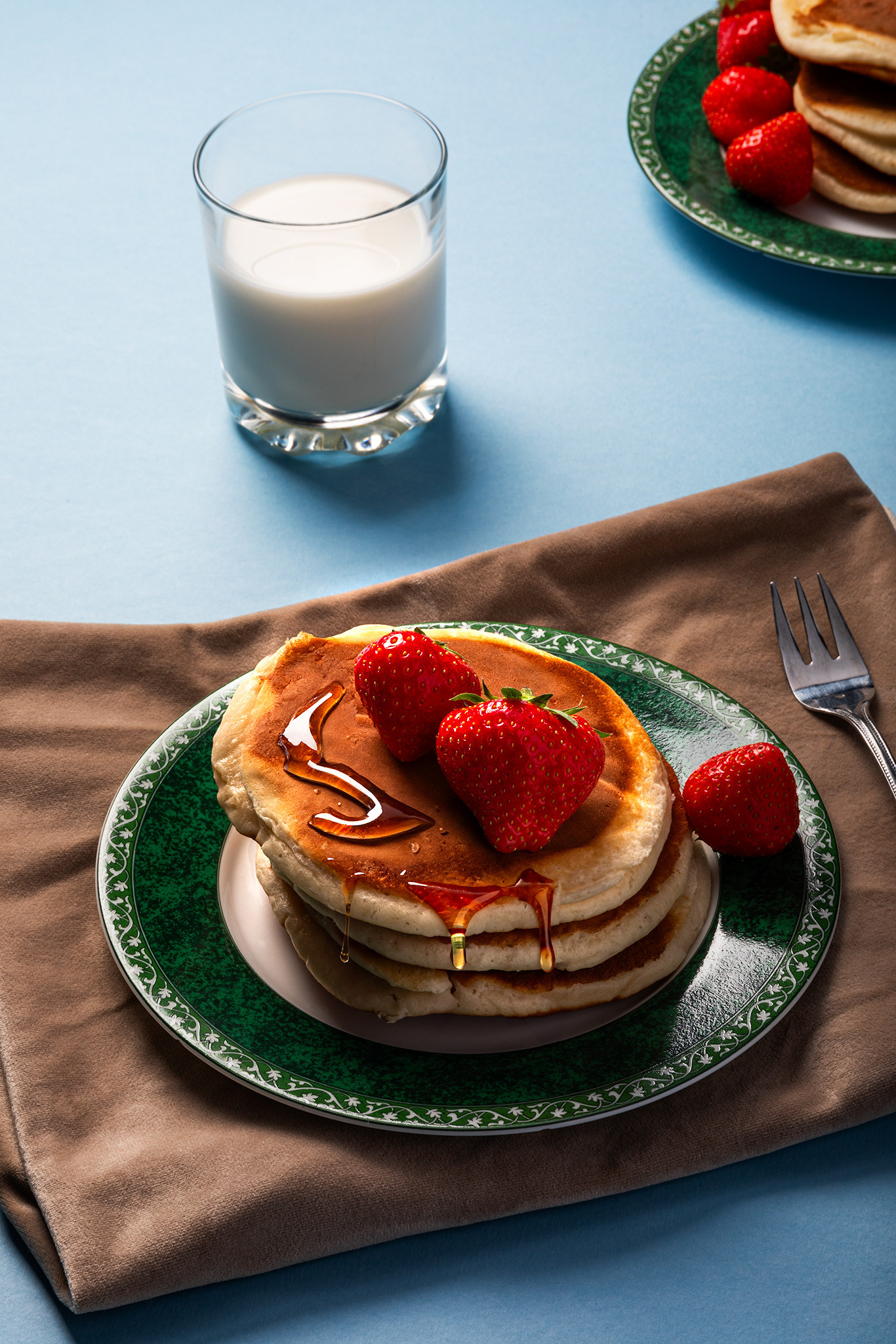 A stack of pancakes and strawberries