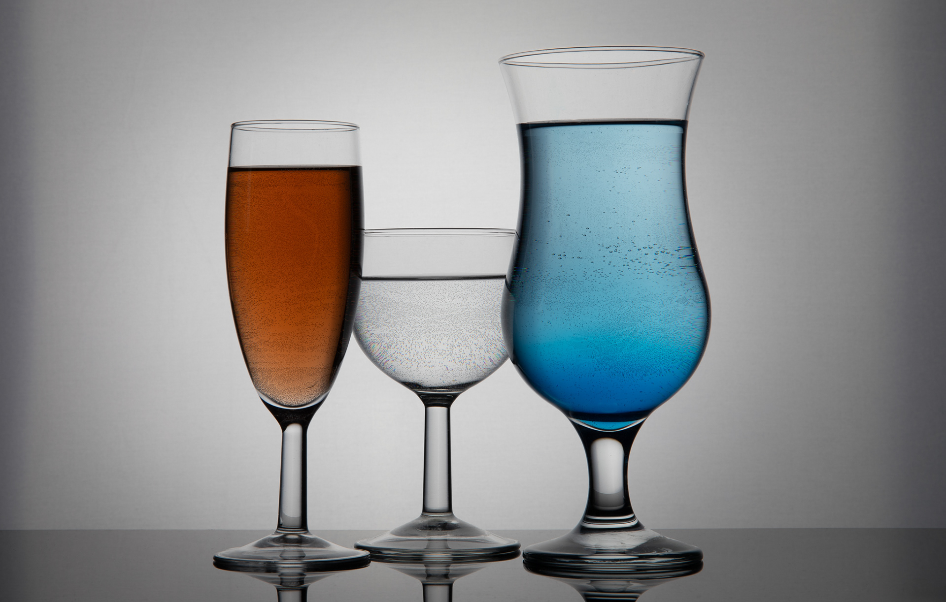 3 glasses with coloures liquid