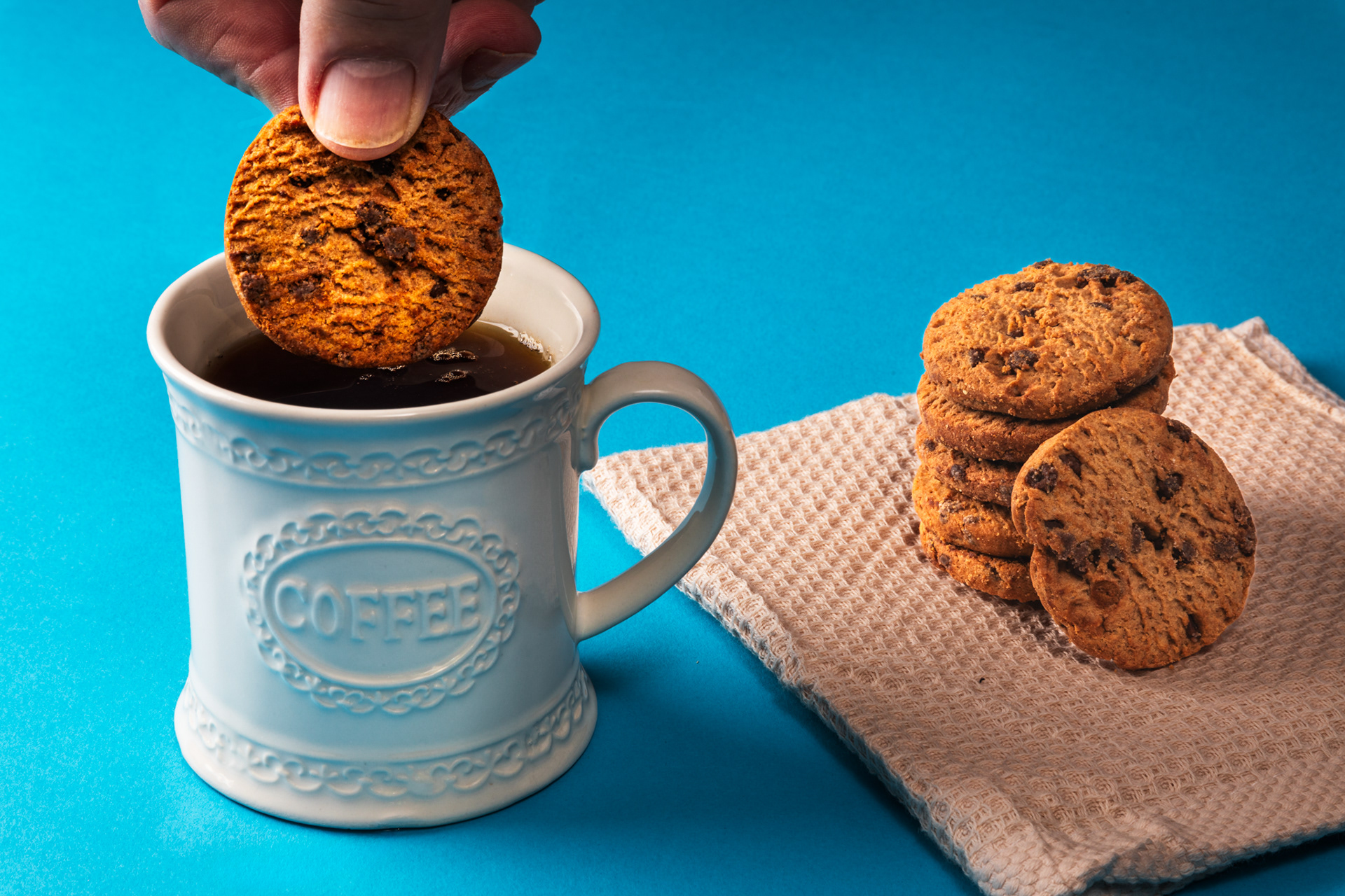 Dunking a cookie in a mug of coffee