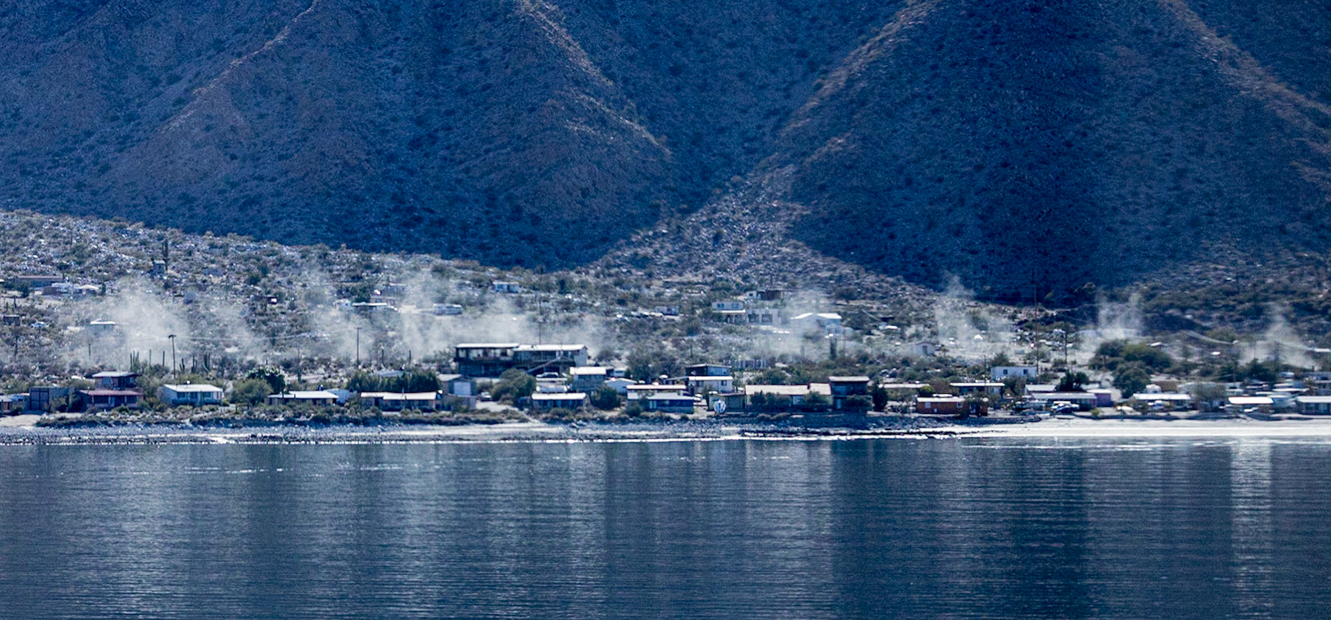 The Cowboy Caravan.   Dust plumes from the army of trucks hired by Lindblad to take us from Bahia de Los Angeles up to the Boojum forest.