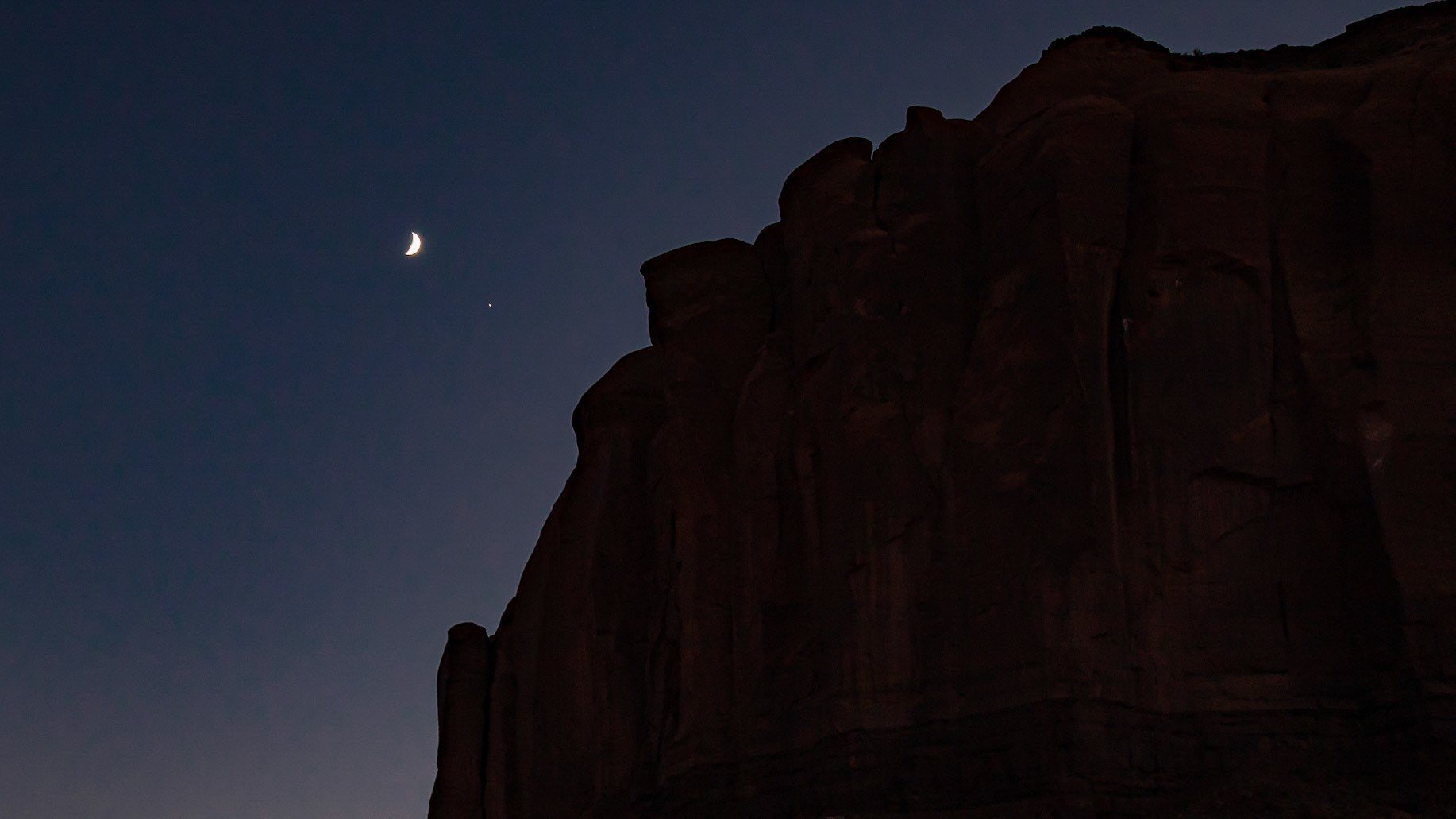 Luna and Jove about to disappear behind the cliff wall.  Monument Valley, Utah.