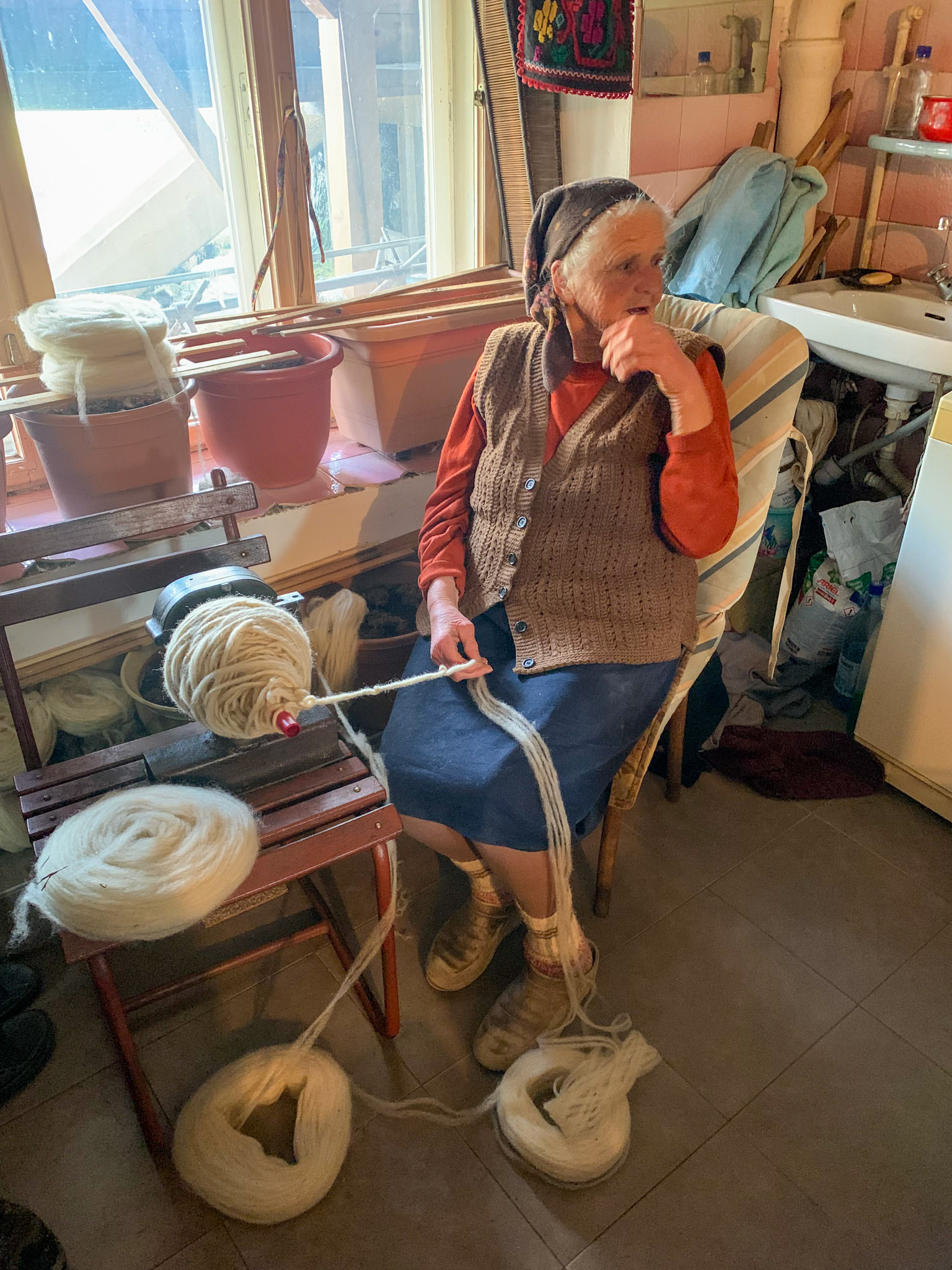 This old lady still continues to spin the threads