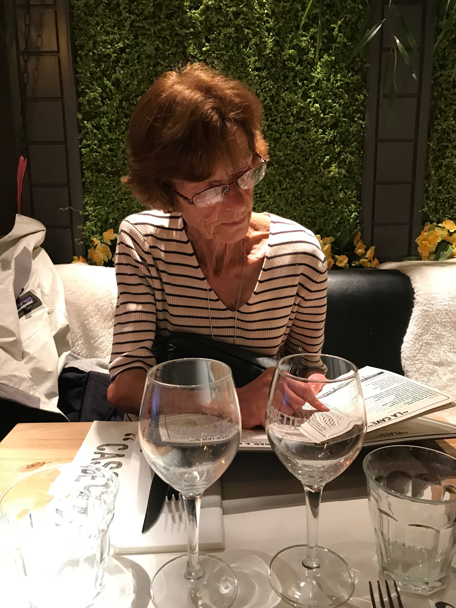 Agnes reviewing a menu, likely considering every detail.