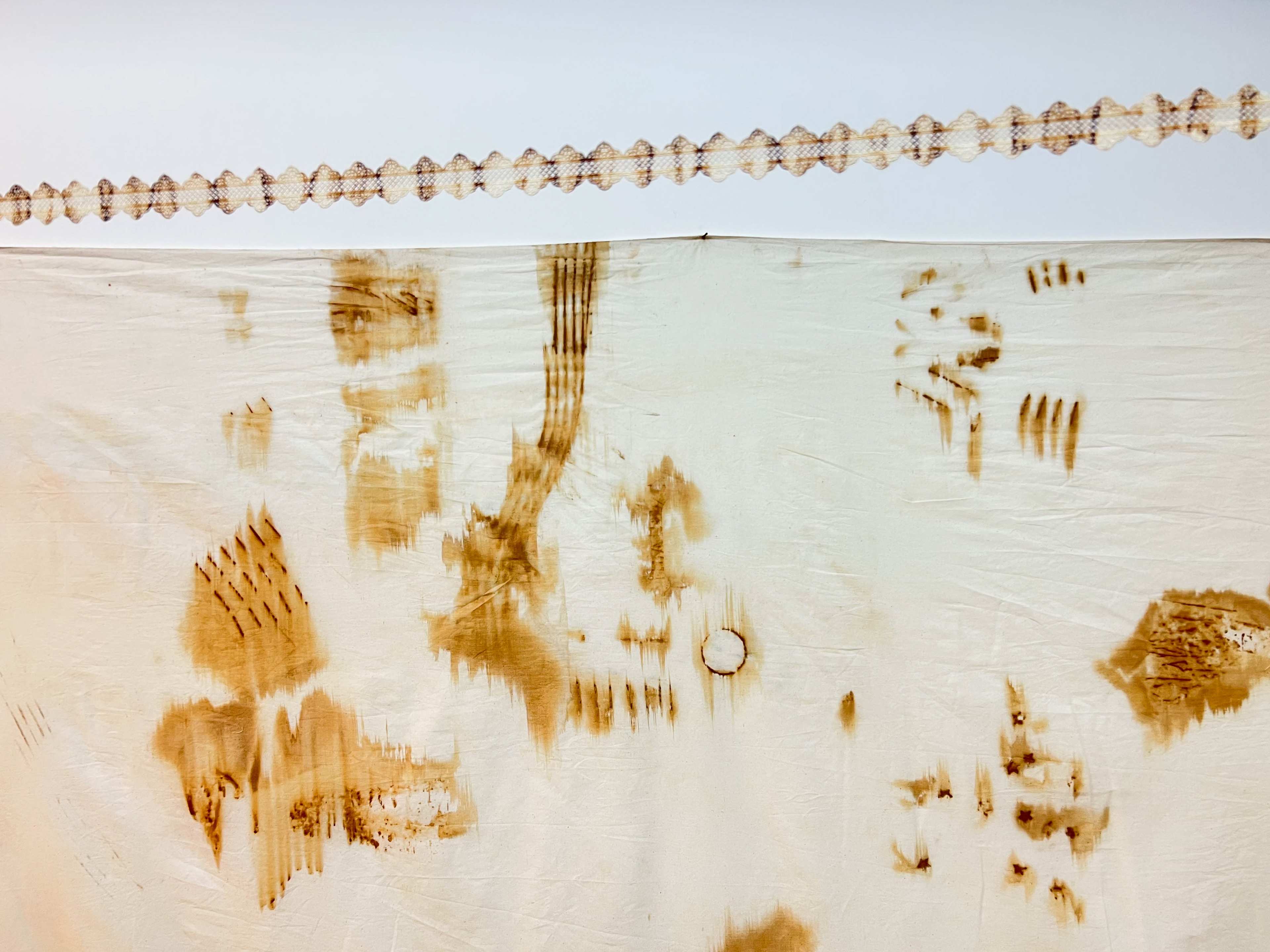Azade, 2022, installation, rust print on laces, dimensions variable / close-up