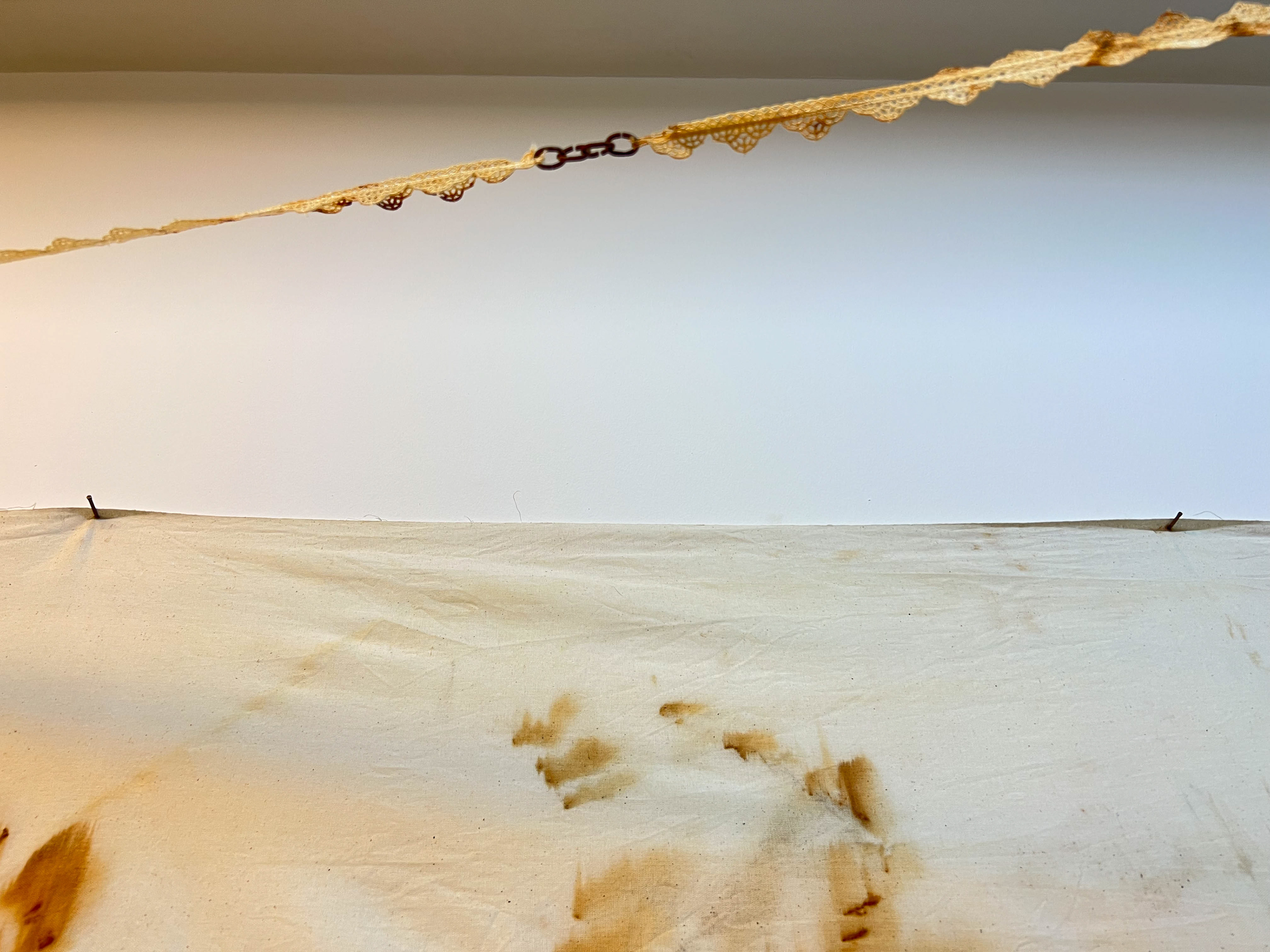 Azade, 2022, installation, rust print on laces, dimensions variable / close-up