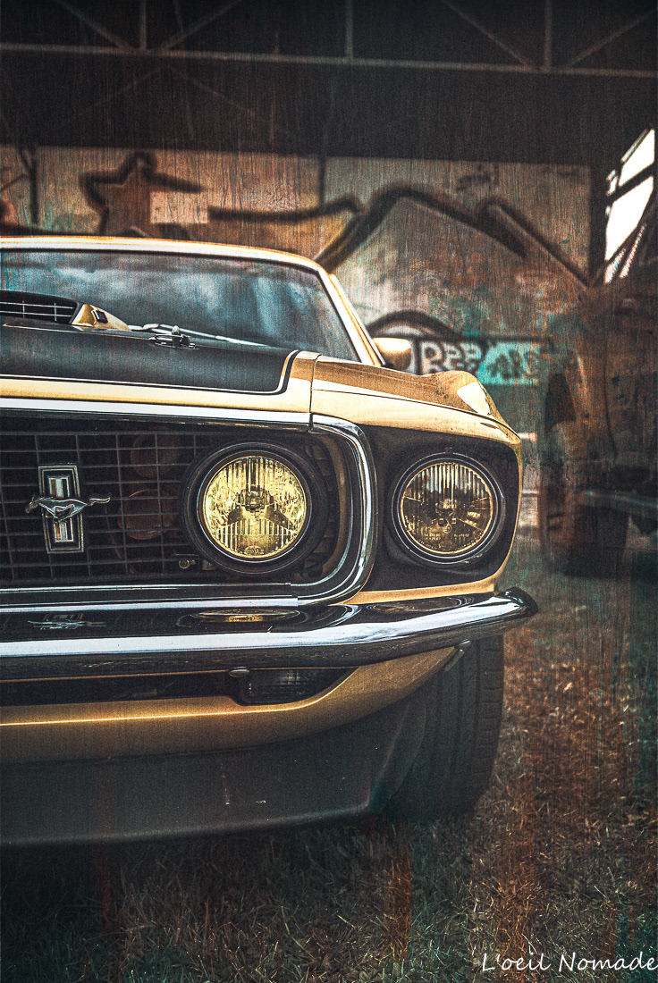 Photographie artistique Ford Mustang jaune dans hangar industriel, style urbain et contrasté L'œil Nomade.