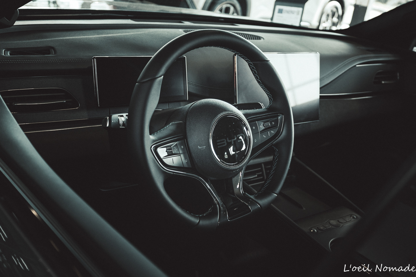 Poste de pilotage et volant automobile BYD, design épuré et technologique, photographie e-commerce de prestige.
