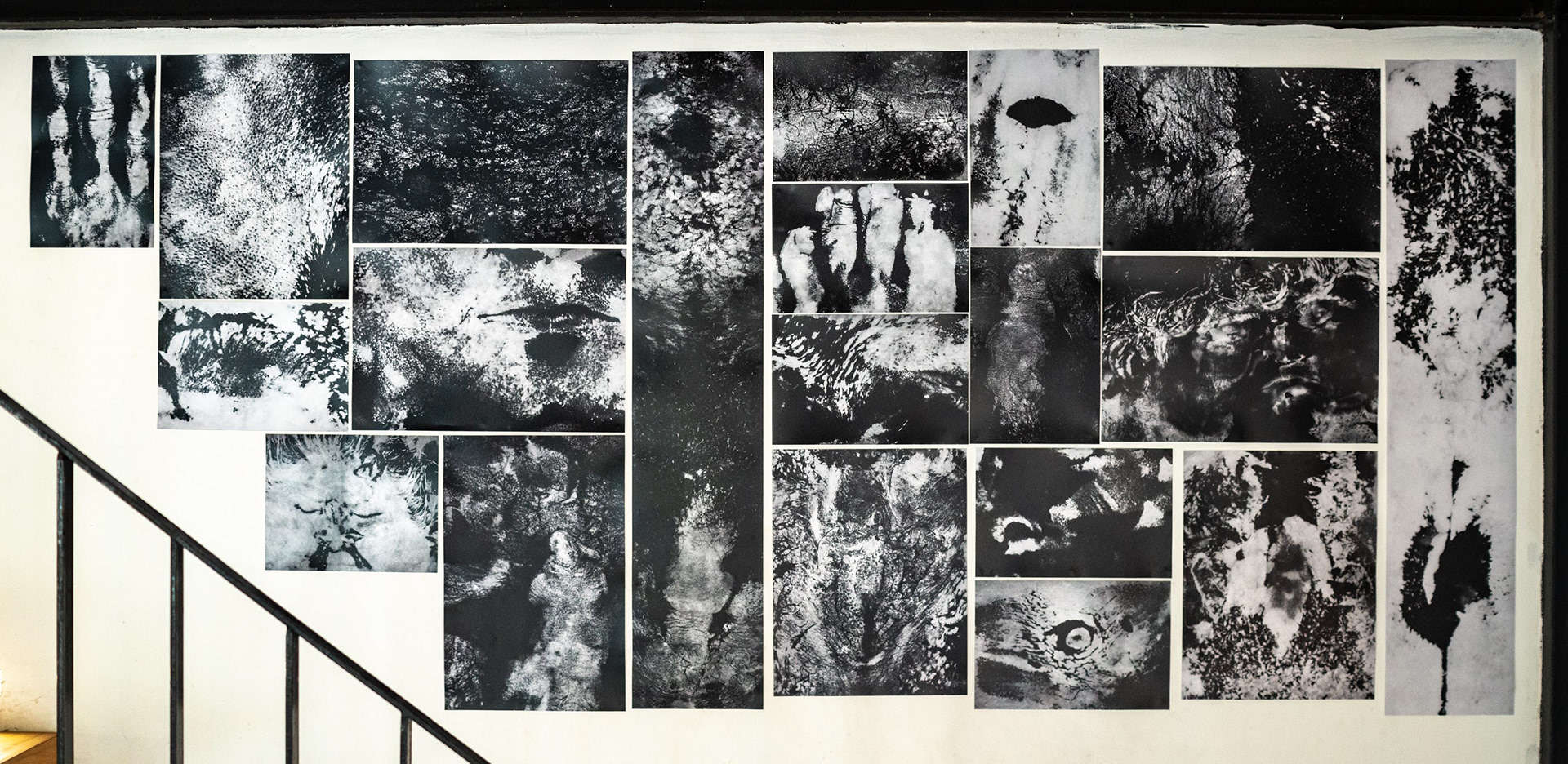 Several images and photos from Tobias Ahlbrecht's One series hung next to a staricase at the Schiller's River Club in Ho Chi Minh City.