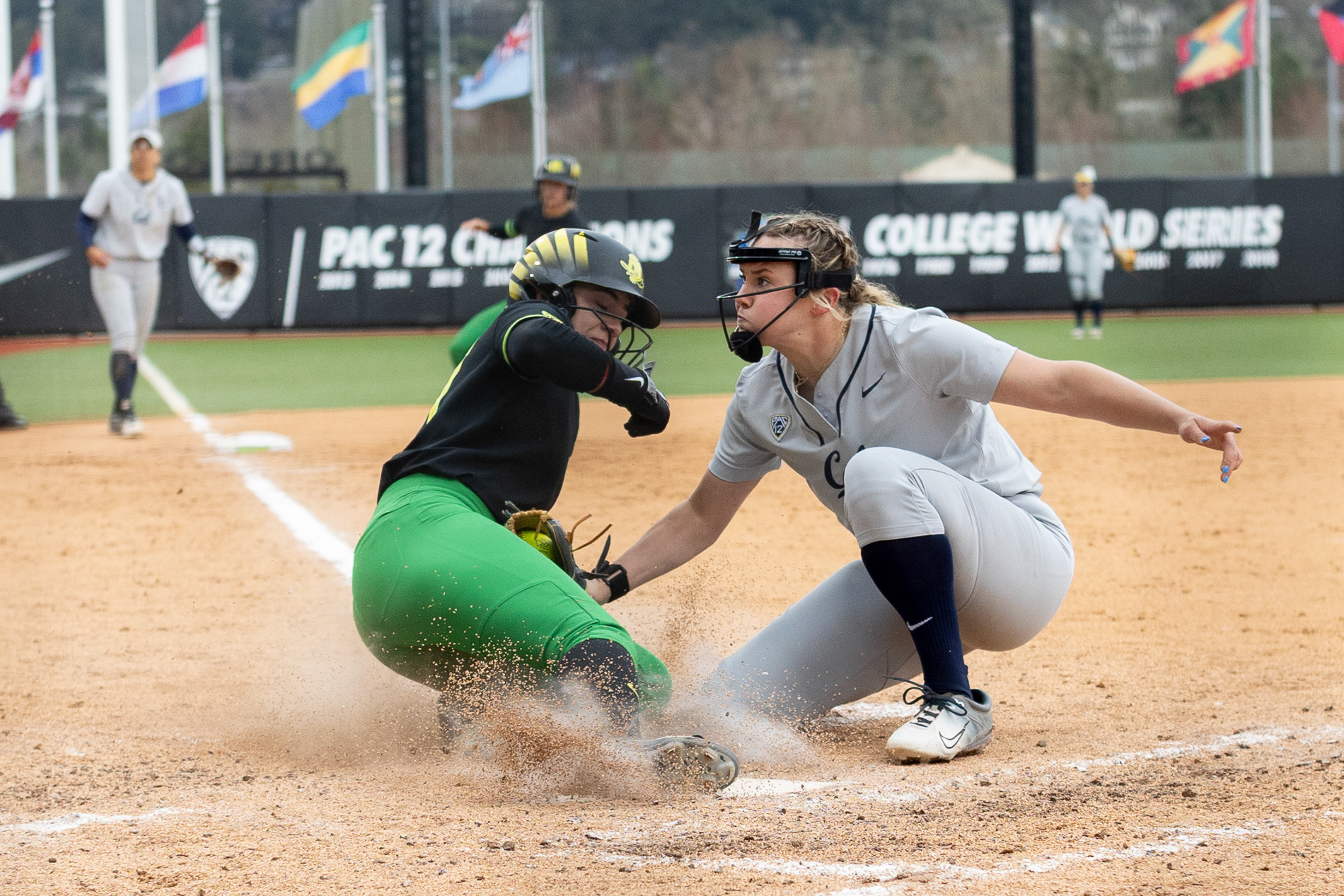 Oregon's Hanna Delgado (24) slides into home plate as UC Berkeley's Randi Roelling (12) looks to tag her. The Oregon women's softball team took a 5-2 win as they faced off against the University of California, Berkeley's Golden Bears at Jane Saunders Stadium on March 9, 2024. | Shot for Emerald Media Group | 1/2000 f/2.8 ISO800