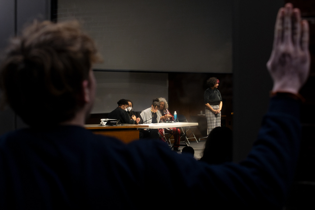 A person looks through a window trying to see and hear Angela Davis' talk on March 6, 2024. Hundreds of people gathered in Straub 156 to hear Angela Davis speak "on apartheid, prisons, and capitalism" at an event organized in collaboration with the UO's Multicultural Center and ROAR Center. The lecture hall has an official capacity of 520, which overfilled within minutes of the doors opening, leaving would-be listeners—some of whom traveled hours to attend the event—to find other ways to see and hear Davis' talk. | Shot for Emerald Media Group