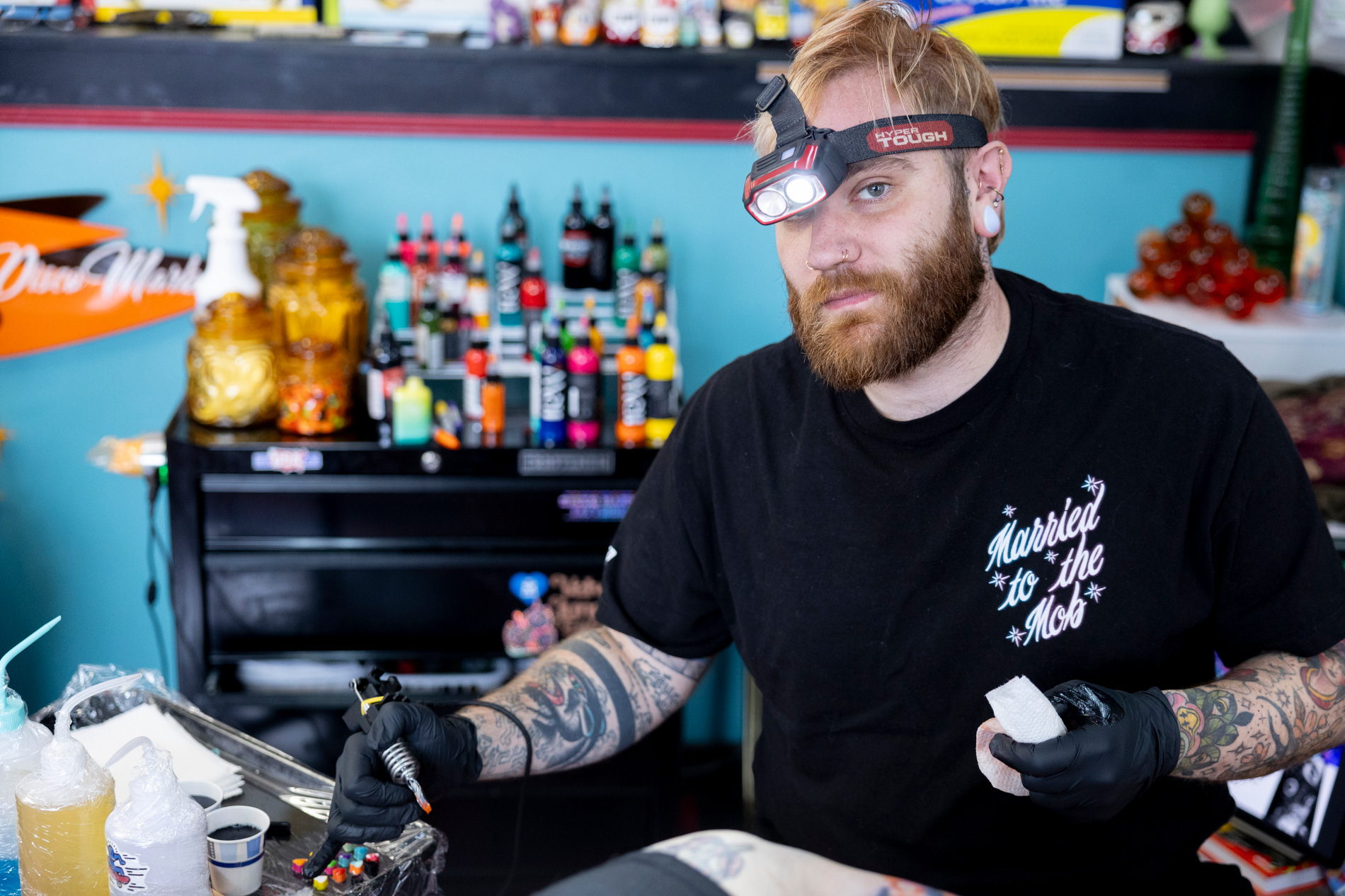 Mark Mullins looks up from tattooing a client at The Parlour Tattoo on March 24, 2024. | Shot for Emerald Media Group