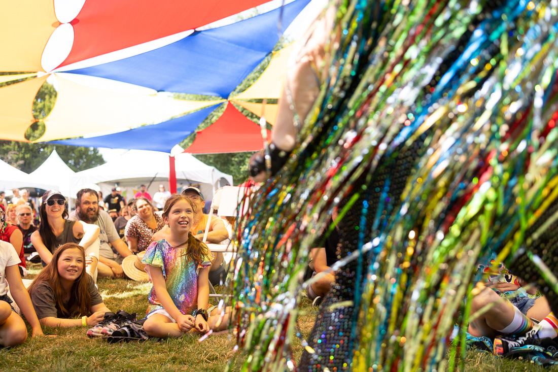 Children watch, smiling, as drag performer Heavy Cream dances through the crowd at the annual Pride in the Park event on August 10, 2024.Community members gathered for Eugene’s annual Pride in the Park—an event held in the city since the 1990s—to celebrate LGBTQ+ people, communities, art and expression. | Shot for Emerald Media Group | 1/2000 f/2.8 ISO400