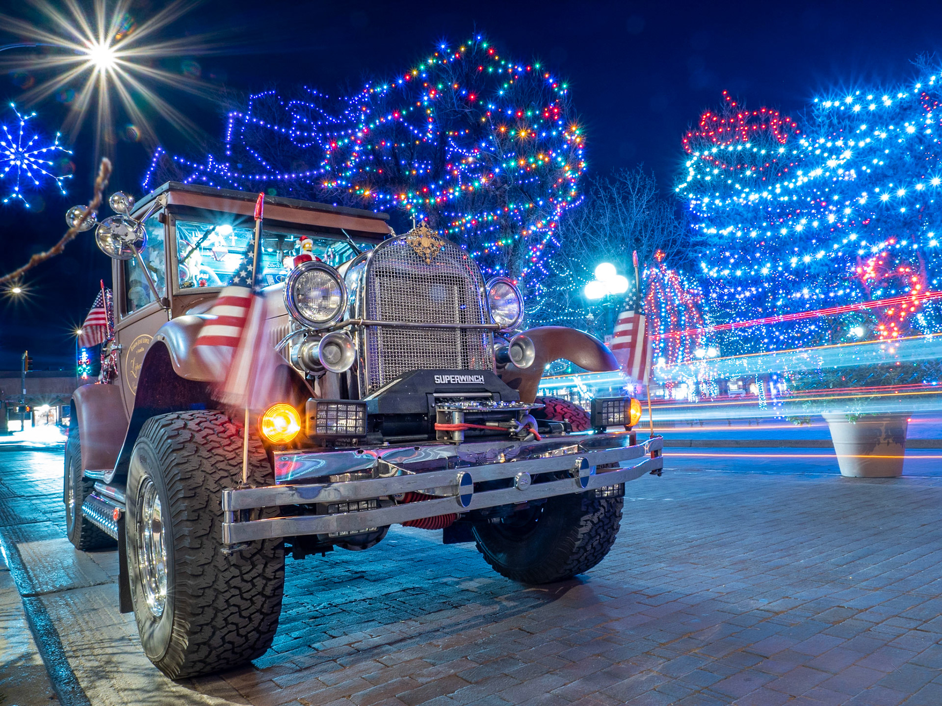 This heavily decorated truck playing Christmas music from a set of speakers was parked on the plaza in Santa Fe this evening and provided a great foreground for this shot of the festive lights.