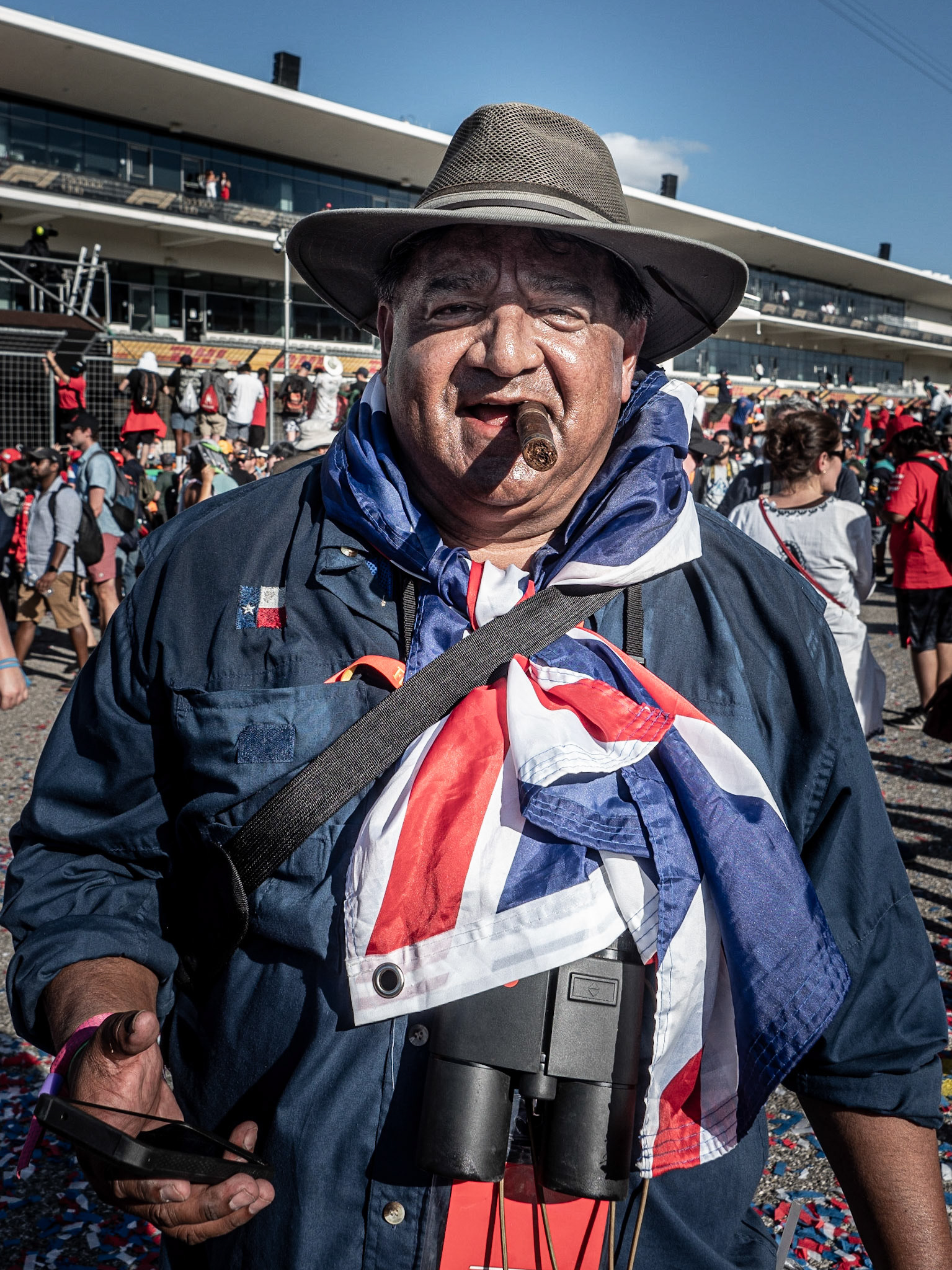 I bumped into this chap during the 2021 US Grand Prix track invasion. Based on the Union Flag around his neck, he must have been a Lewis Hamilton, Lando Norris or George Russell supporter. The fact that his cigar remains unlit, leads me to assume that Lewis was probably his man and he didn't feel like celebrating after his driver's second place in the race.