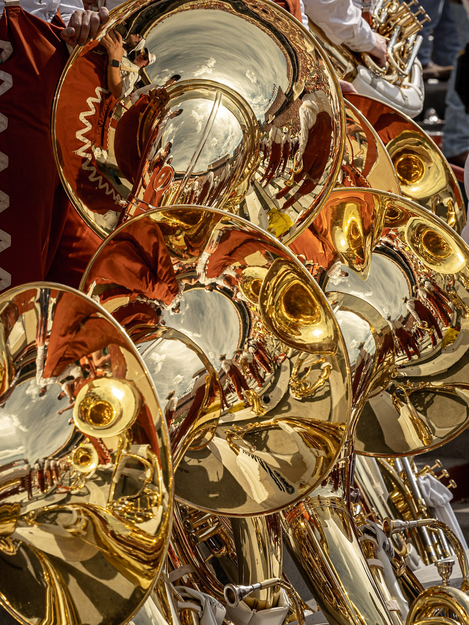 Assorted reflections in a collection of University of Texas Longhorn Band tubas creates an interesting abstract image.