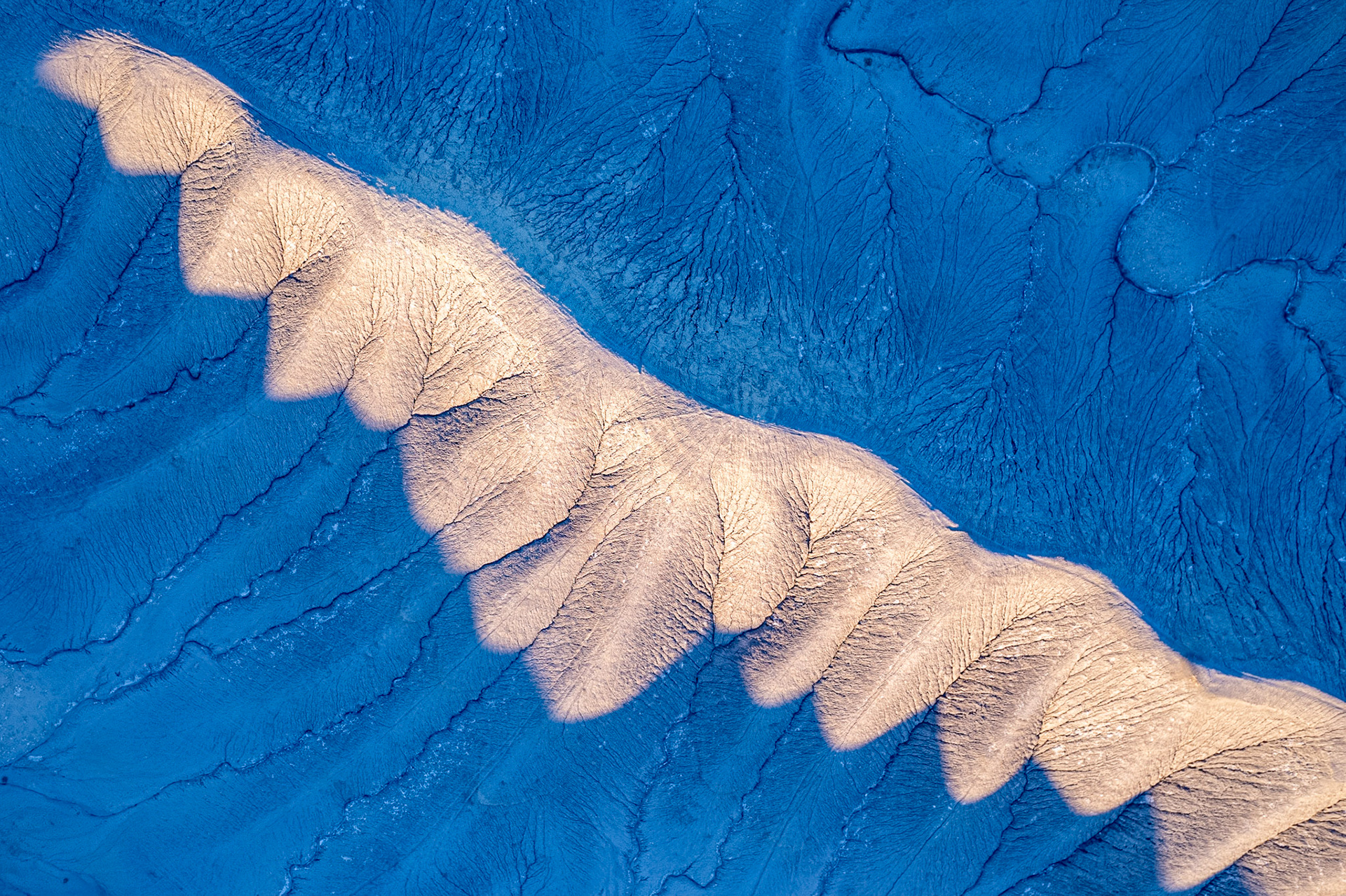 An overhead image of a ridge near Factory Butte in Utah, taken just before sunset.