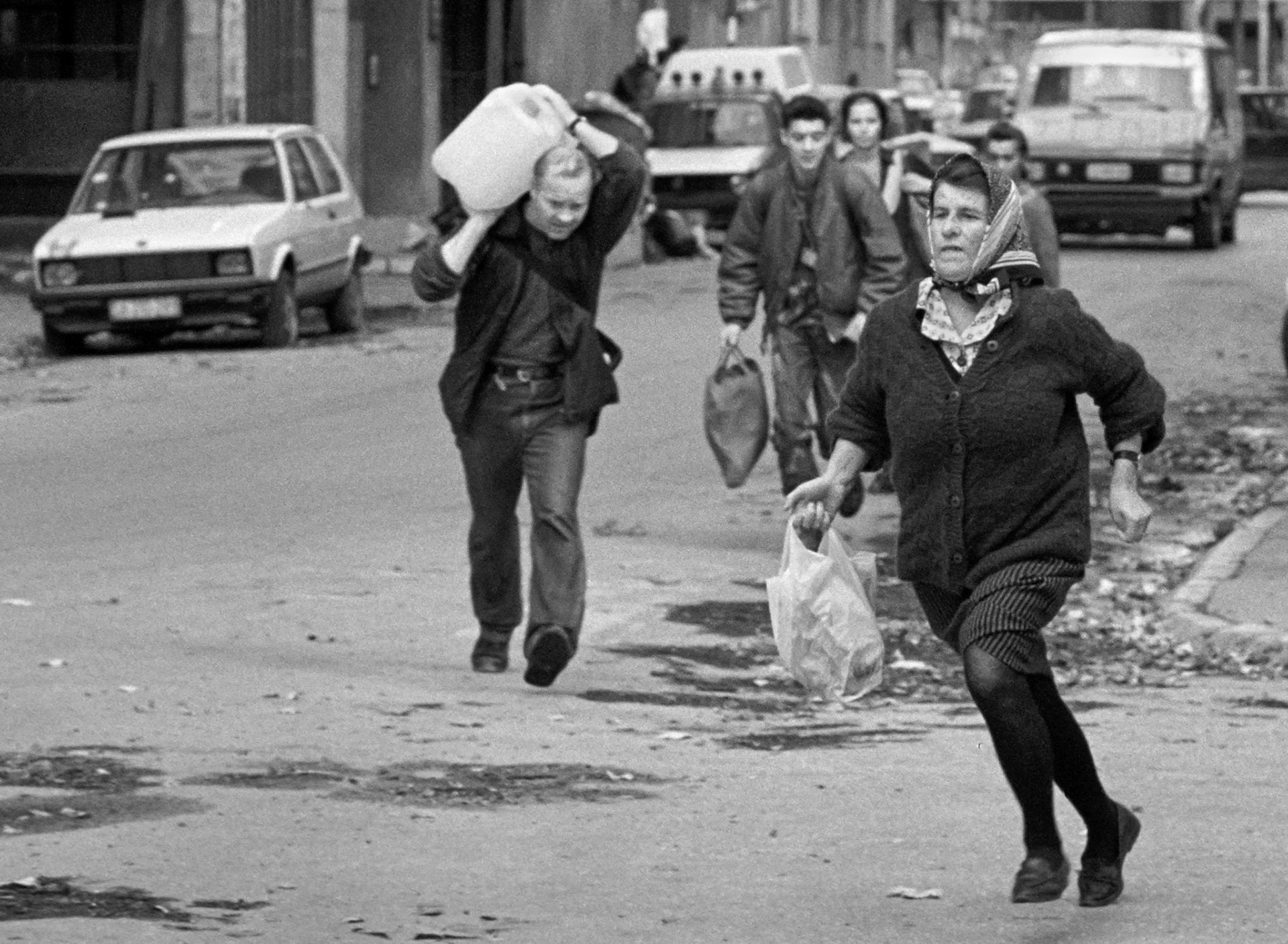 Bosnian civilians run across Sarajevo's notoriously dangerous "Sniper Alley" on November 29, 1992.