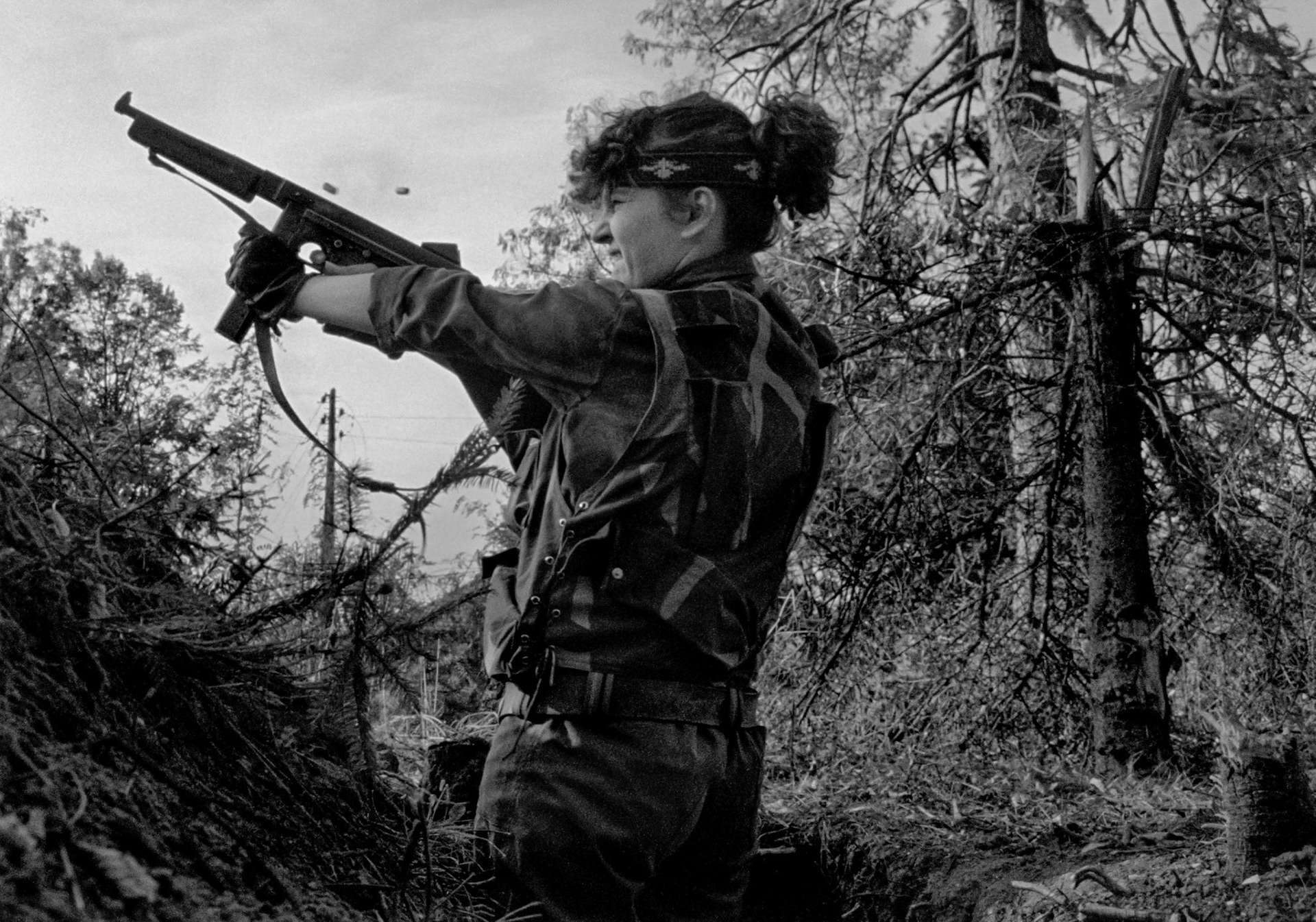 A young female member of the Bosnian Army fires a vintage Thompson sub-machine gun at Bosnian Serb Army positions in Sarajevo's Dobrinja suburb on June 30, 1992.